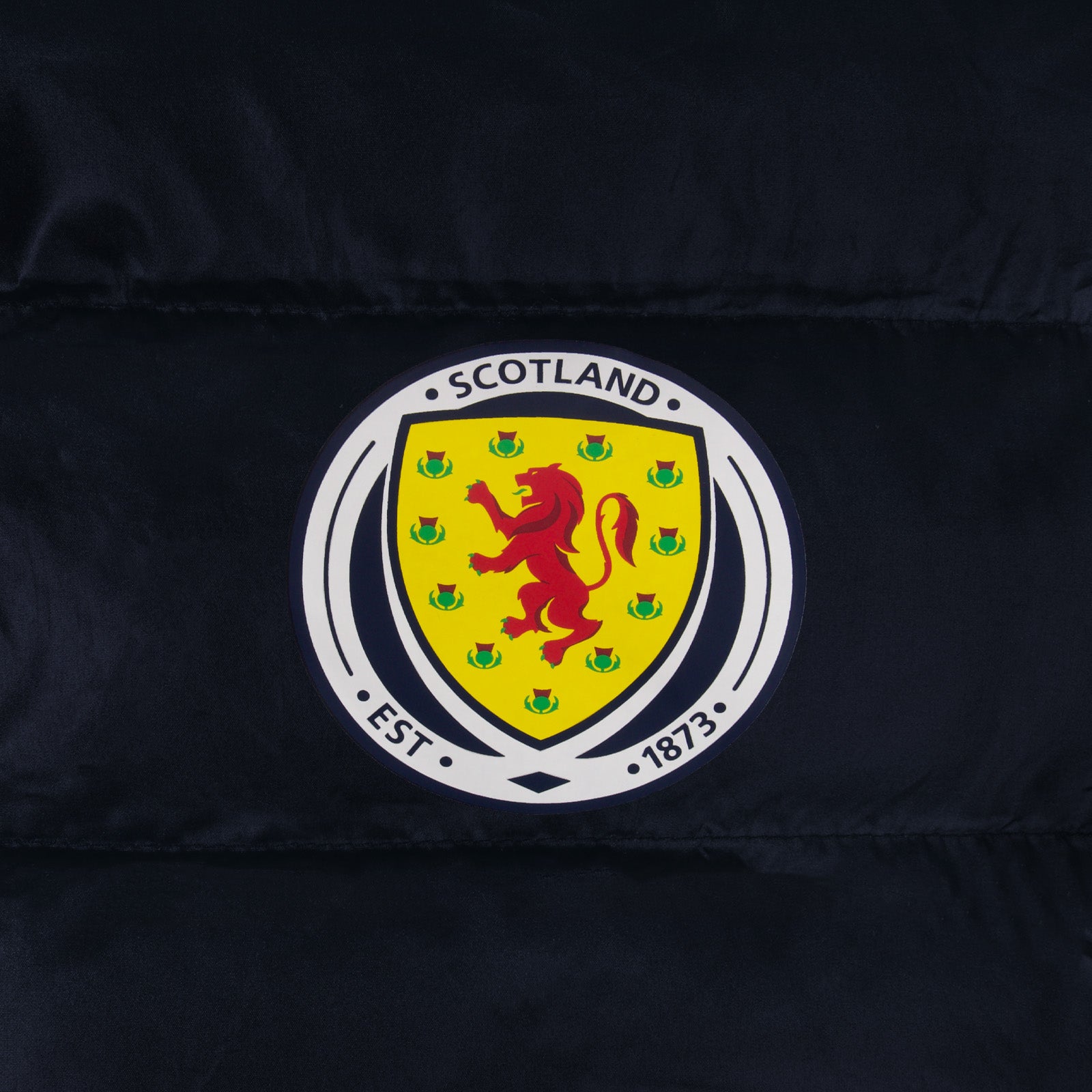 Scotland kids quilted jacket in navy blue with national team crest print to chest.