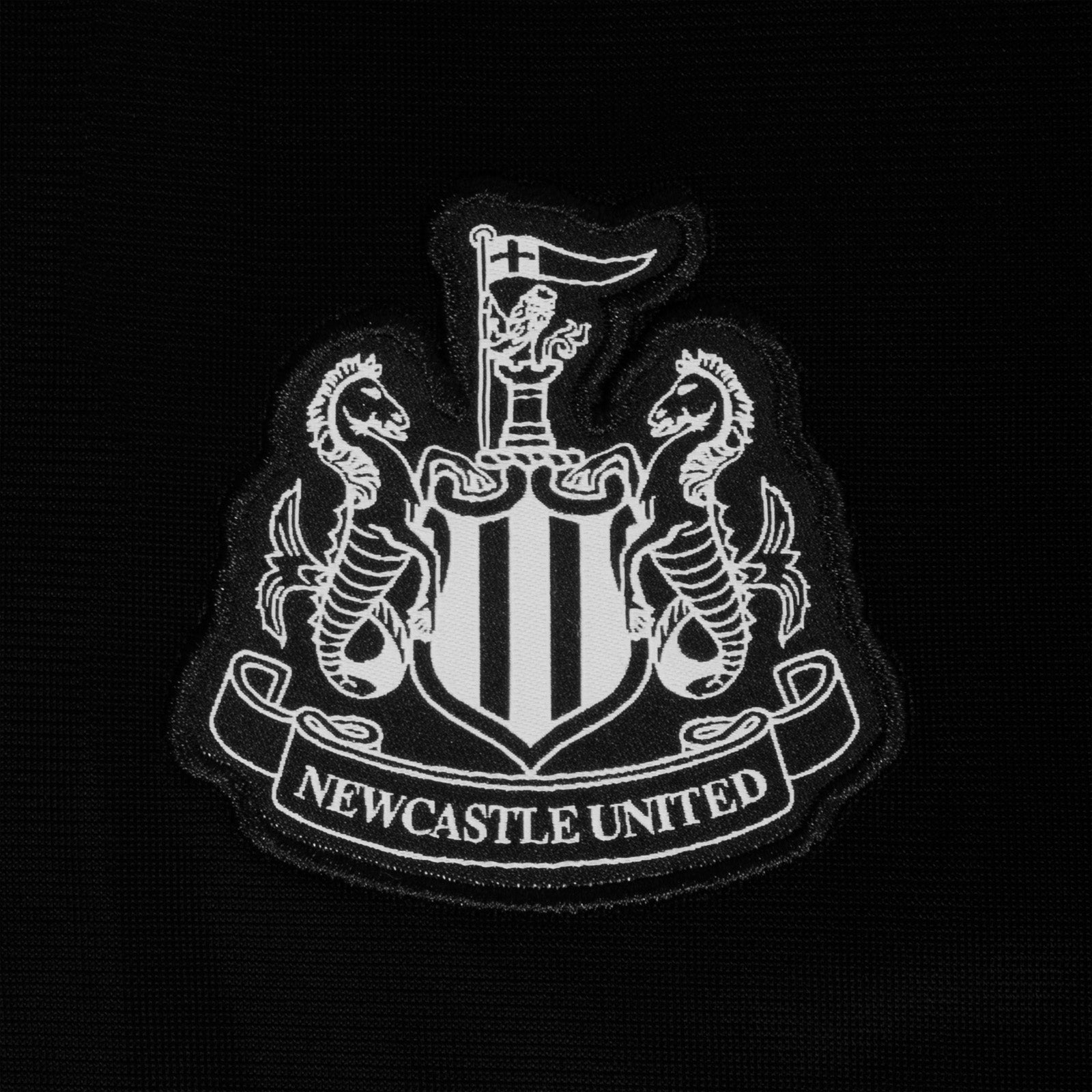 Newcastle United adults taped tracksuit in black with club crest and text to both top & pants