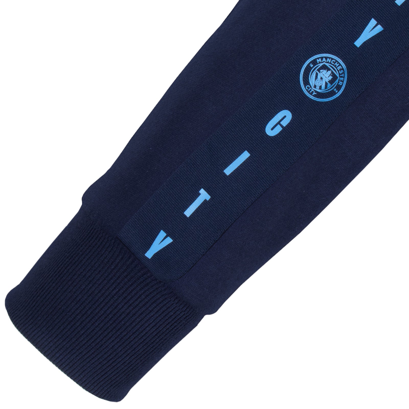 Manchester City adults taped sweatshirt in navy blue with club crest to chest and text to sleeves.