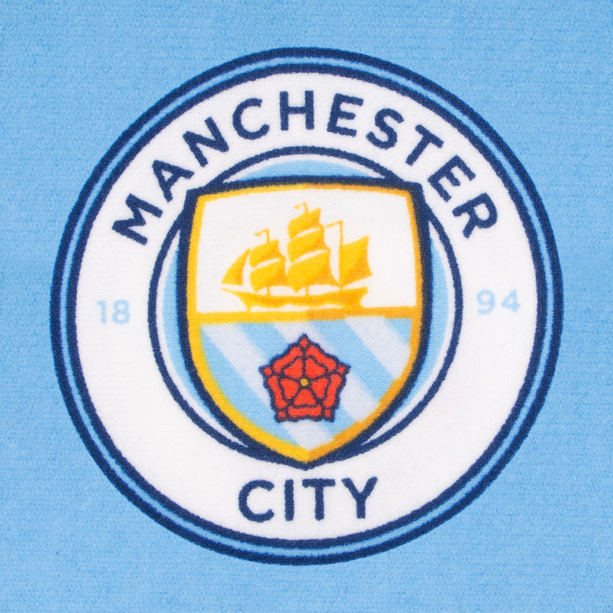 Manchester City kids loungewear pyjama set. Short sleeve t-shirt in white with Man City crest to chest. Long pants in sky blue with all-over print of the club crest