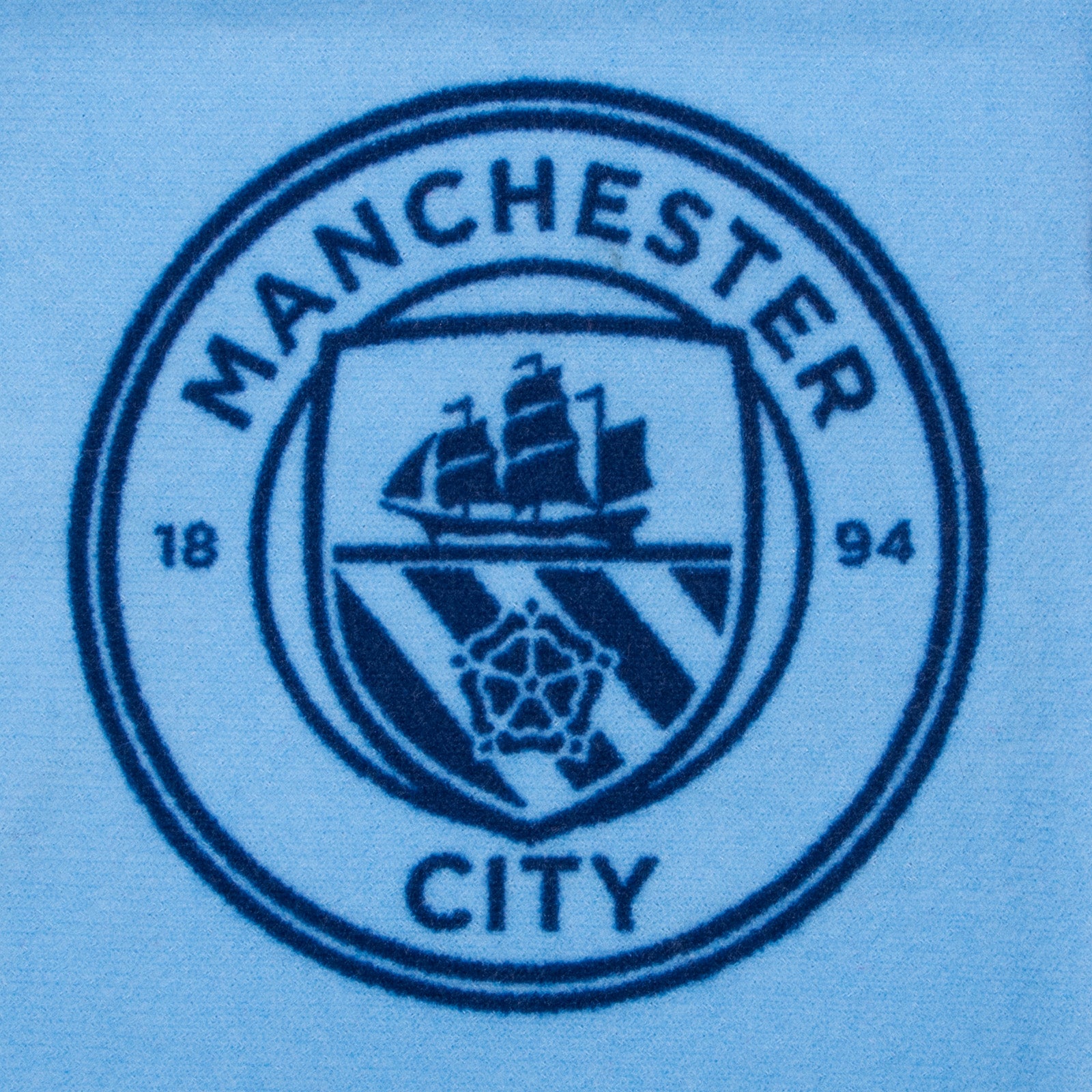 Manchester City kids loungewear pyjama set. Short sleeve t-shirt in white with Man City crest to chest. Long pants in sky blue with all-over print of the club crest