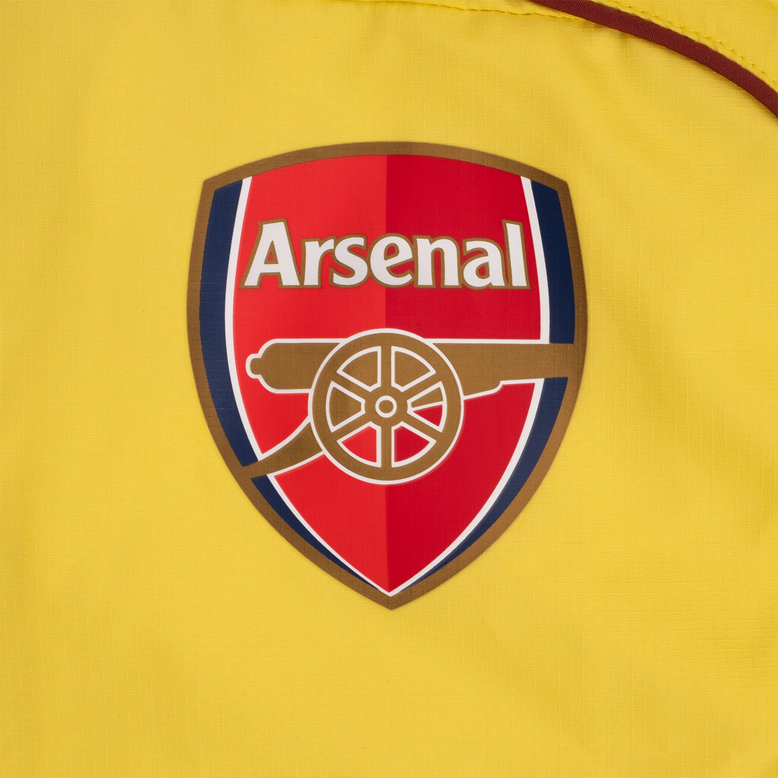 Arsenal adults shower jacket in yellow with club crest to chest