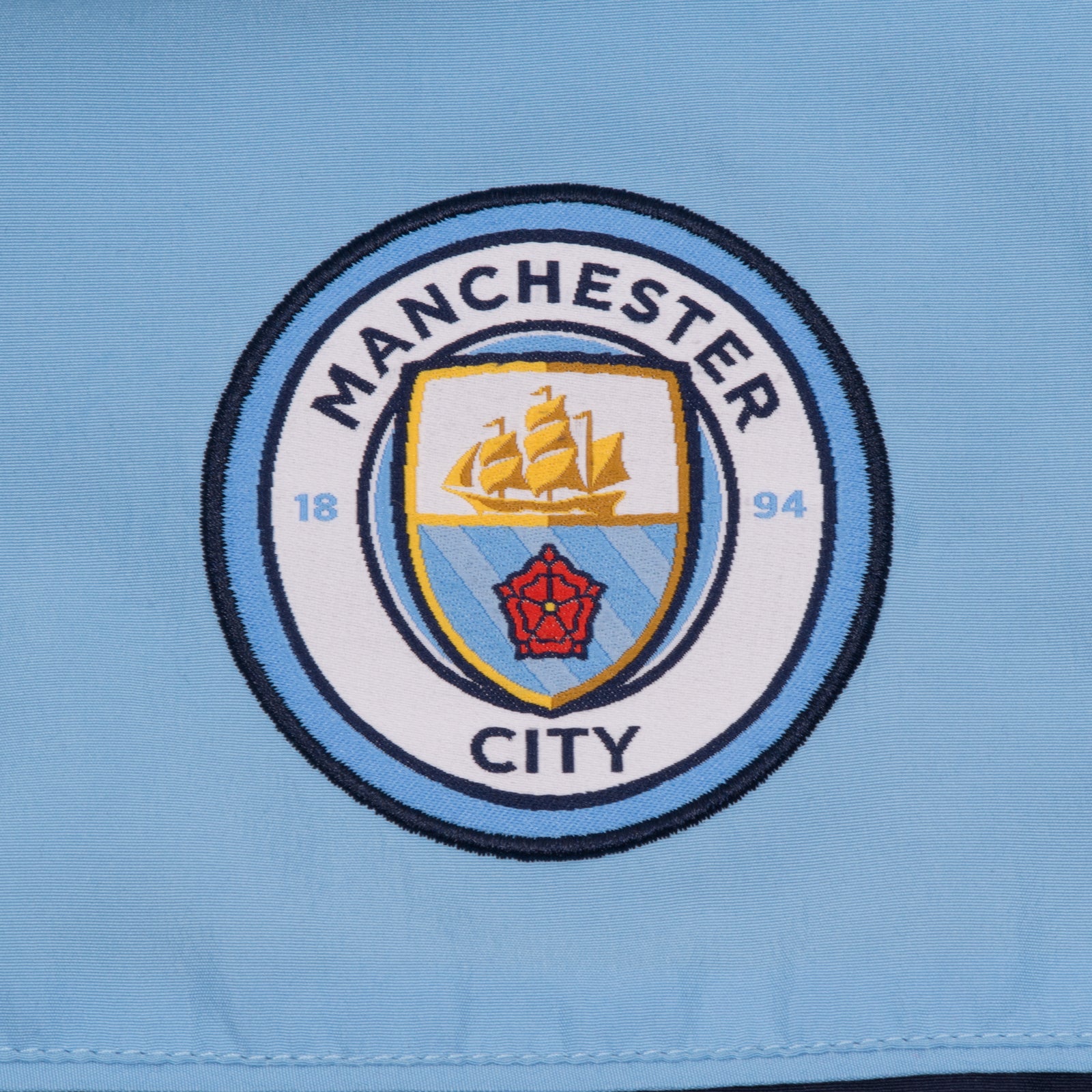 Man City adults tracksuit in navy blue with club crest to chest and left thigh
