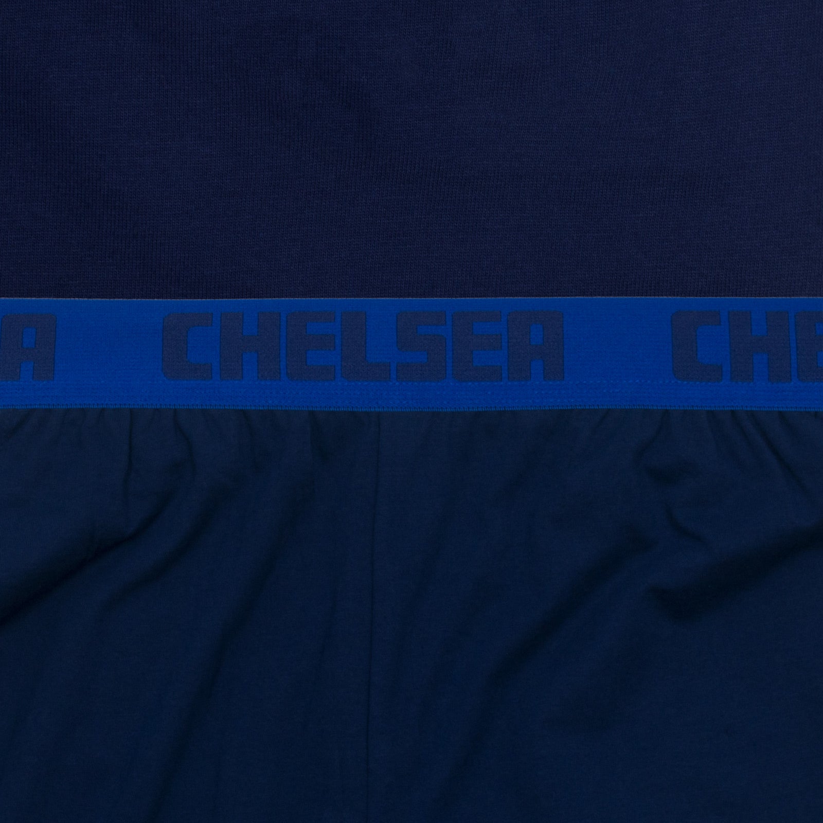 Chelsea adults long yjamas in navy blue. Two-tone short sleeve top with club crest and long pyjama bottoms with badge