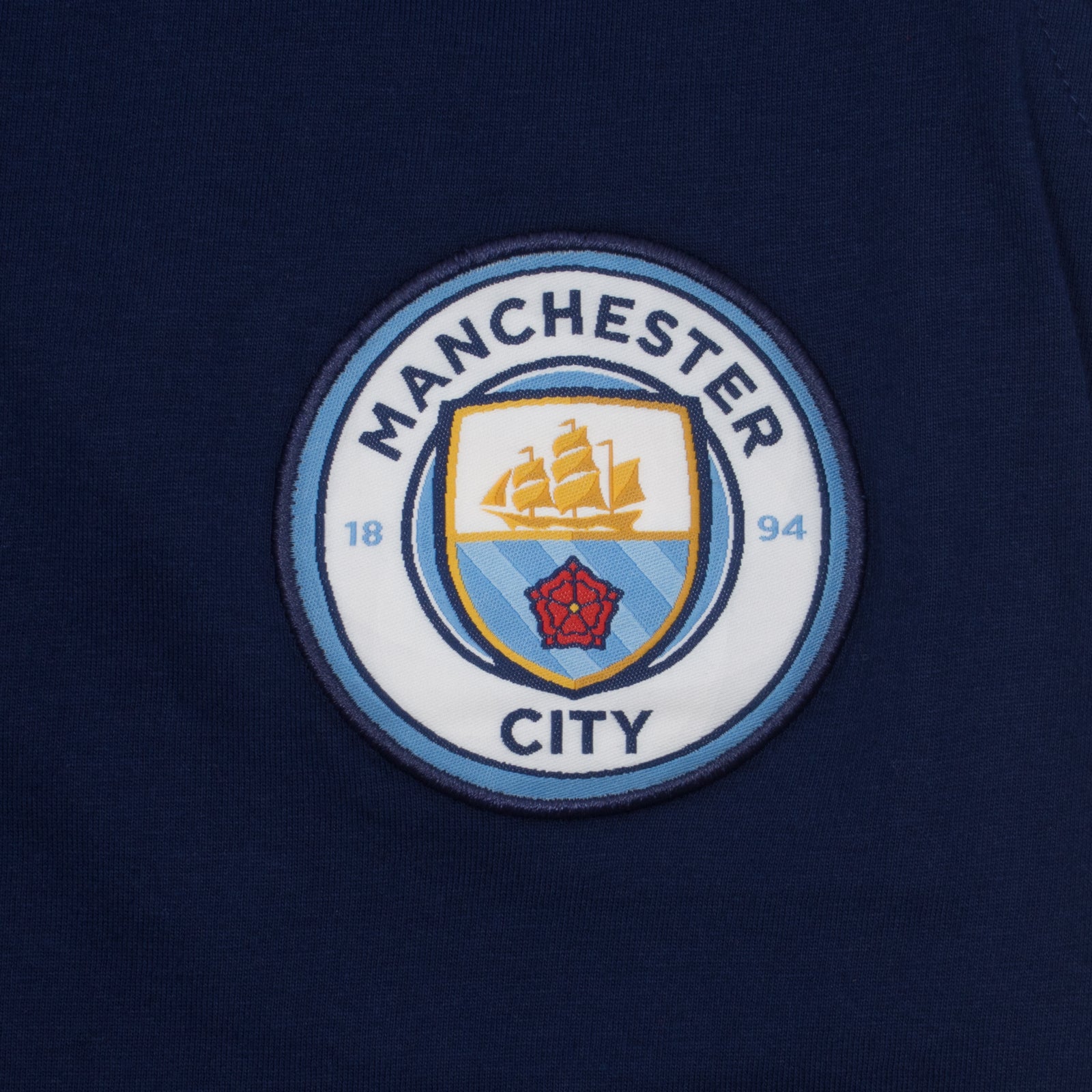 Man City adults long pyjamas in navy & sky blue. Two-tone short sleeve top with crest and long bottoms with badge