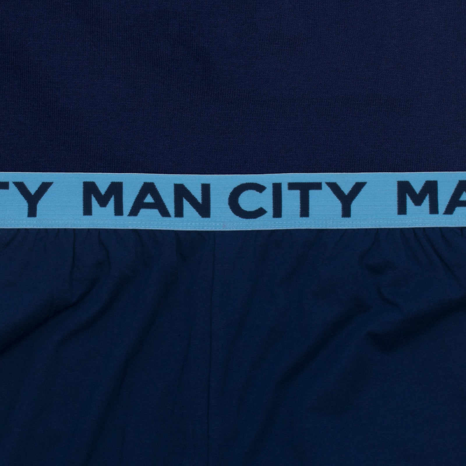 Man City adults long pyjamas in navy & sky blue. Two-tone short sleeve top with crest and long bottoms with badge