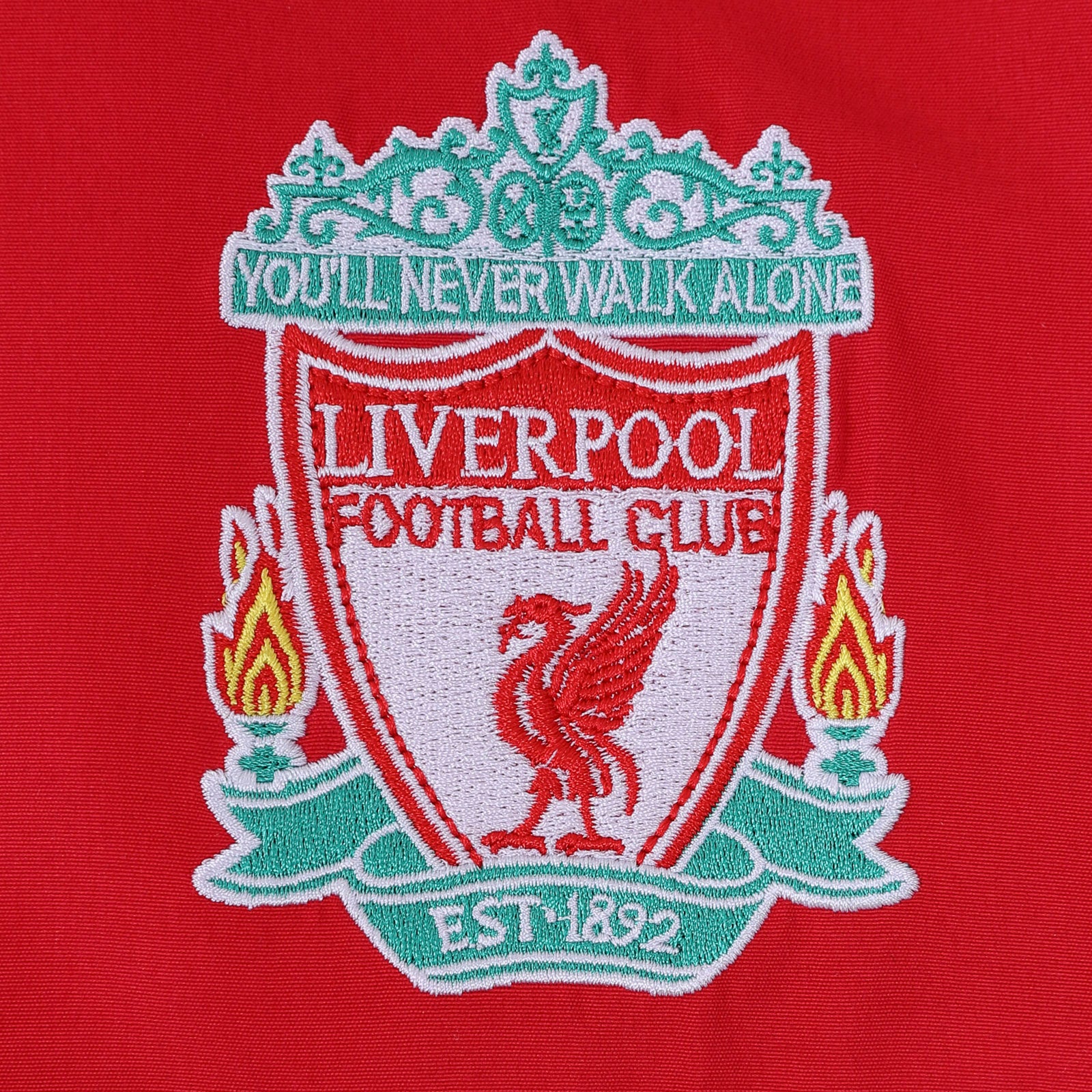 Liverpool kids tracksuit in navy blue with club crest to chest and left thigh