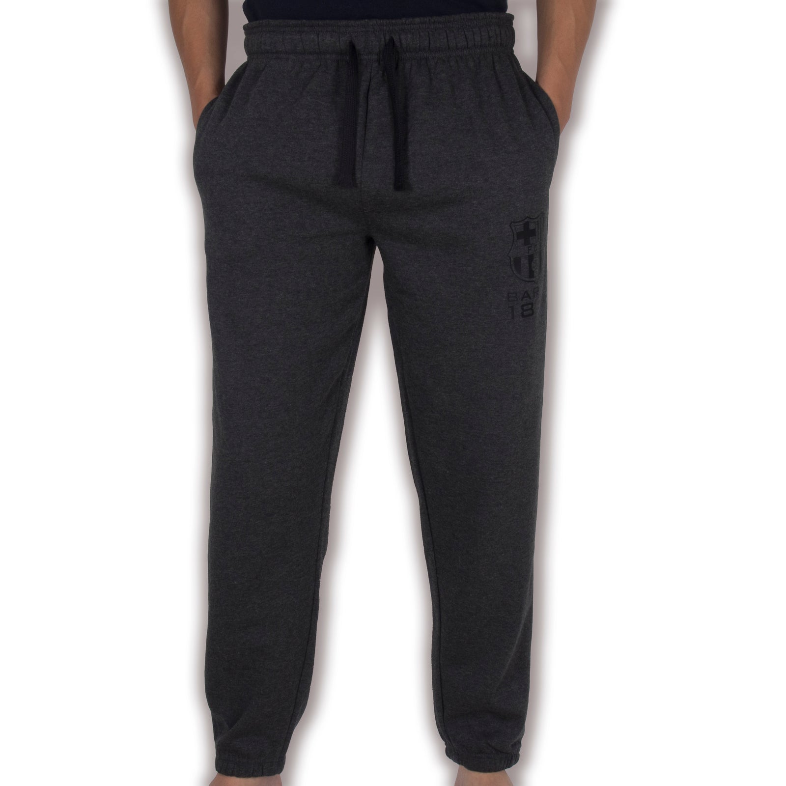 FC Barcelona adults track pants in grey with club crest and text print on left leg.