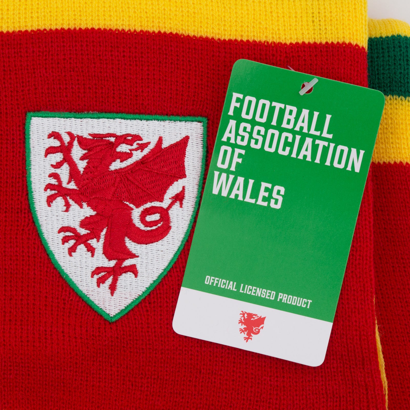Wales bar scarf & bobble hat in red, yellow & green with Wales crest to hat & to end of the scarf.
