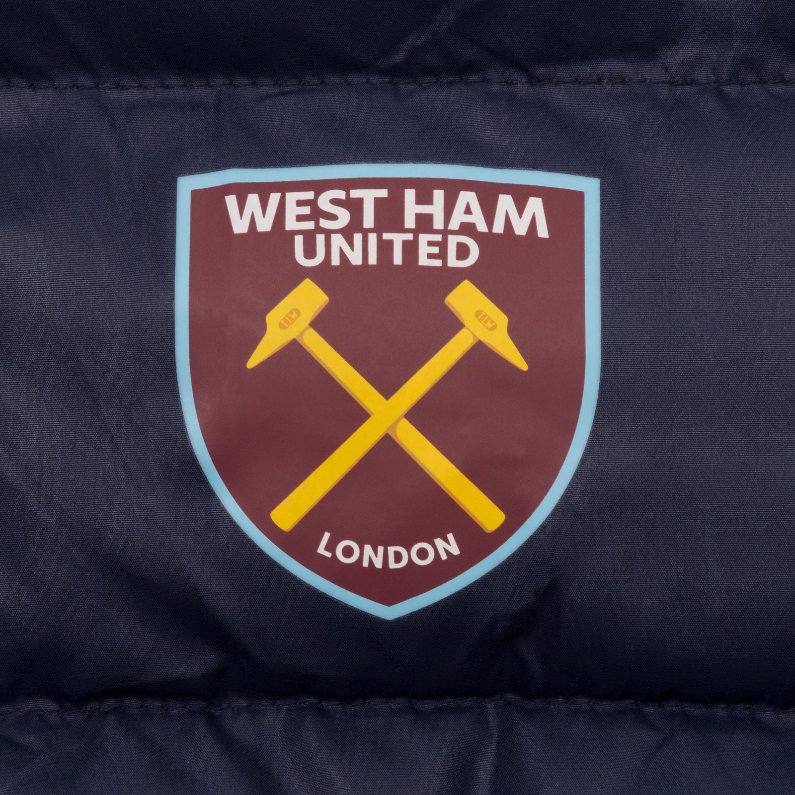 West Ham kids quilted jacket in navy blue with club crest to chest.