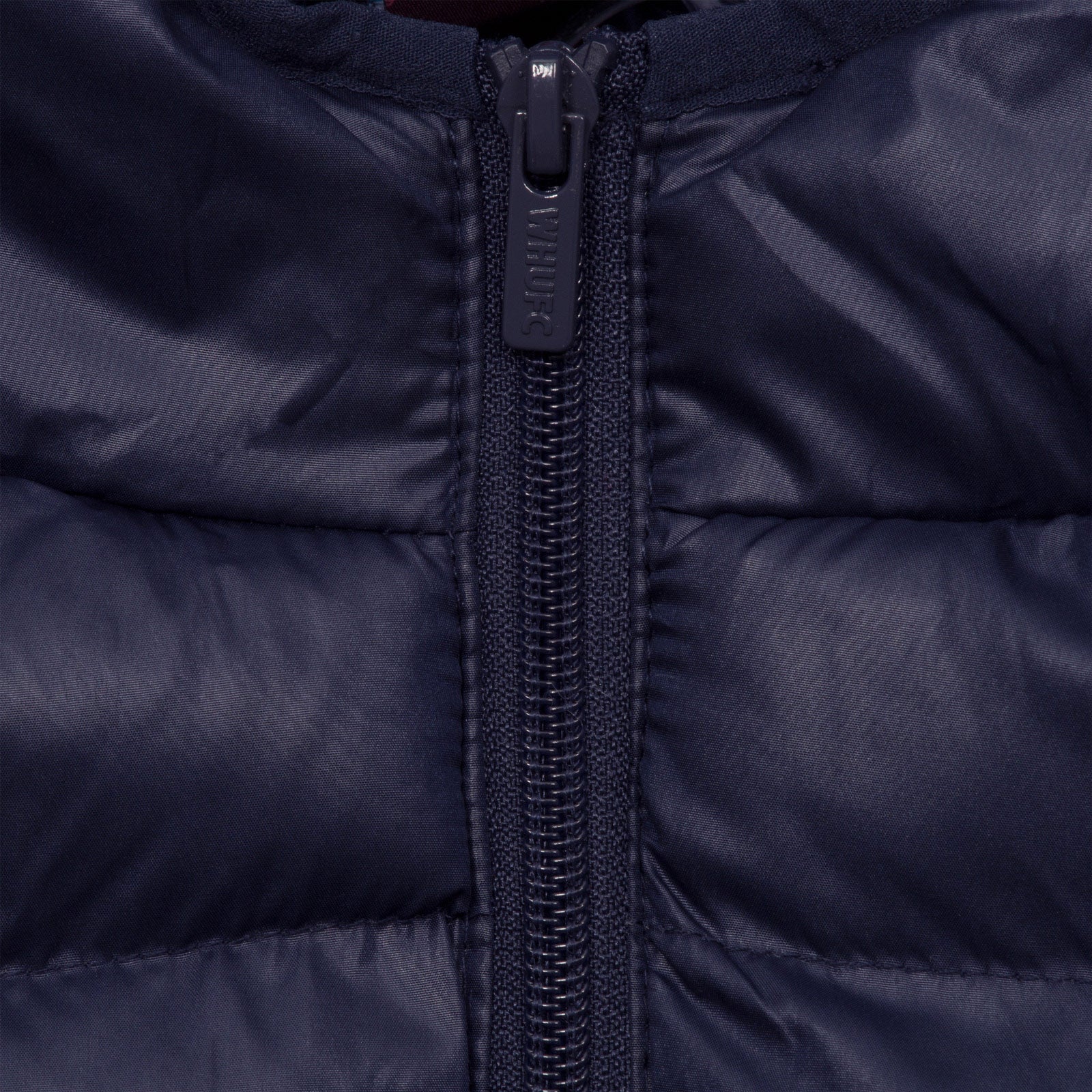 West Ham kids quilted jacket in navy blue with club crest to chest.