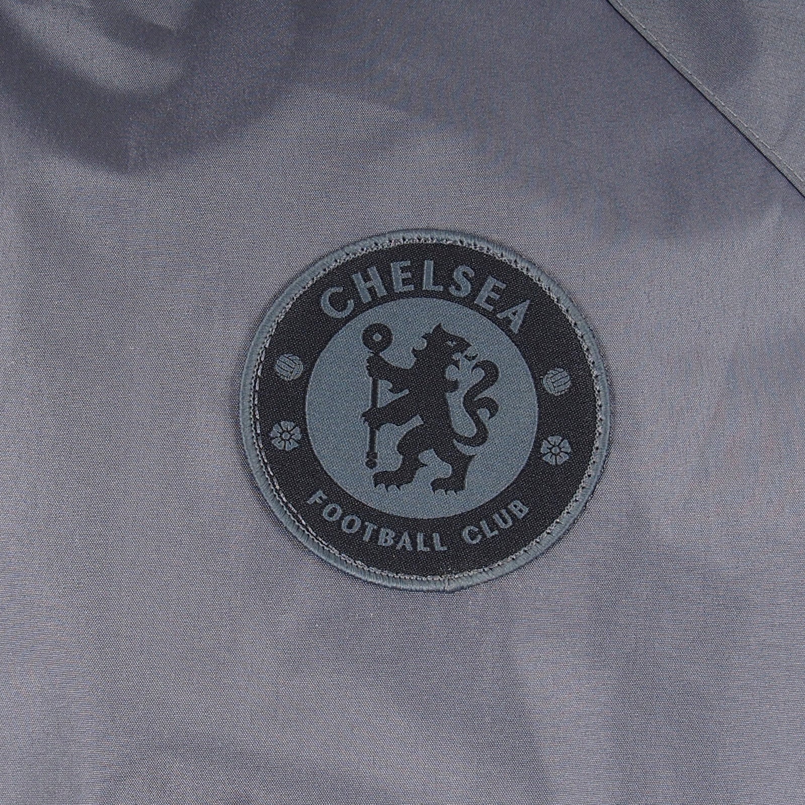 Chelsea adults shower jacket with hood in grey with club crest to chest.