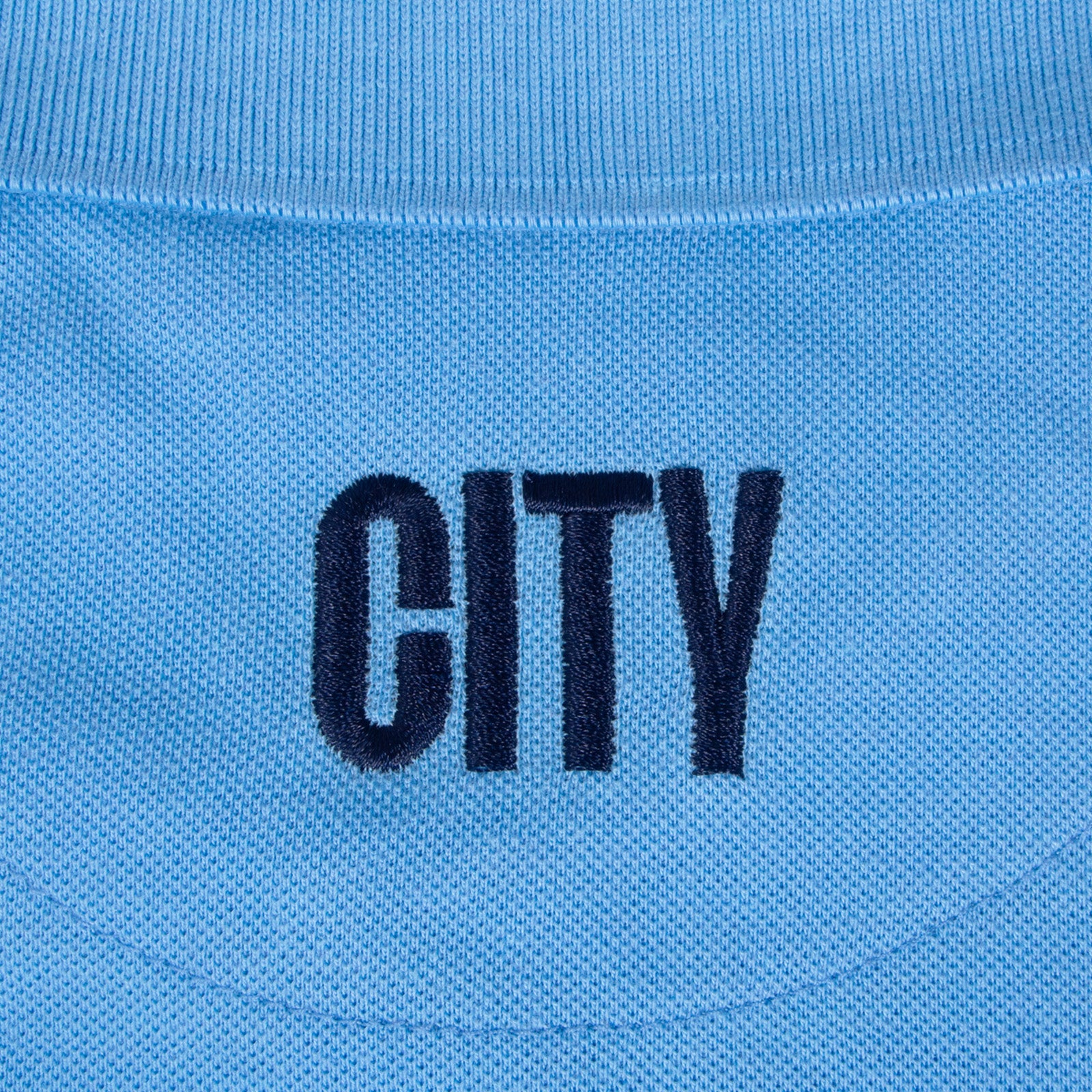 Man City adults polo shirt in sky blue with club crest to the chest.