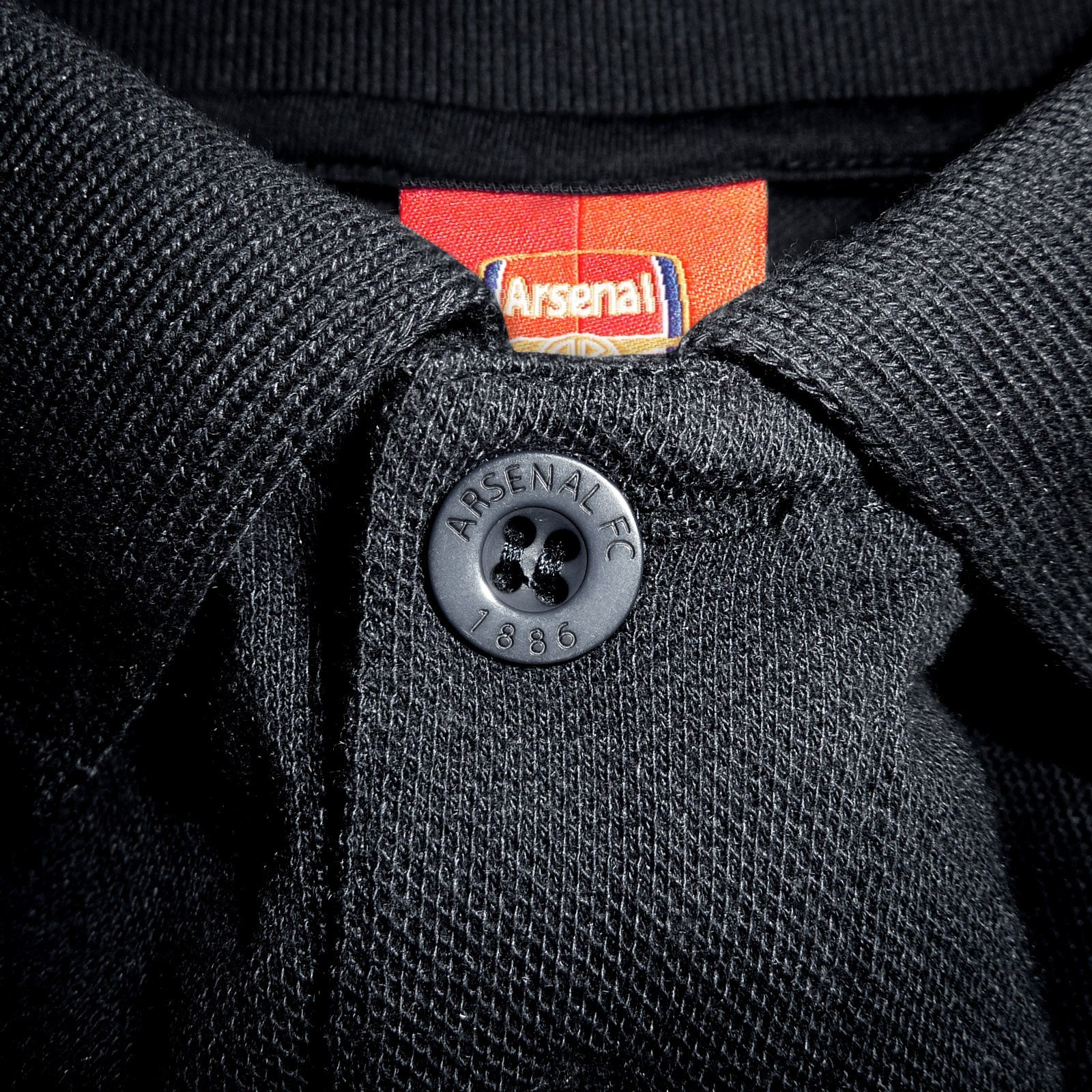 Arsenal polo shirt for adults in black with club crest and canon to chest.