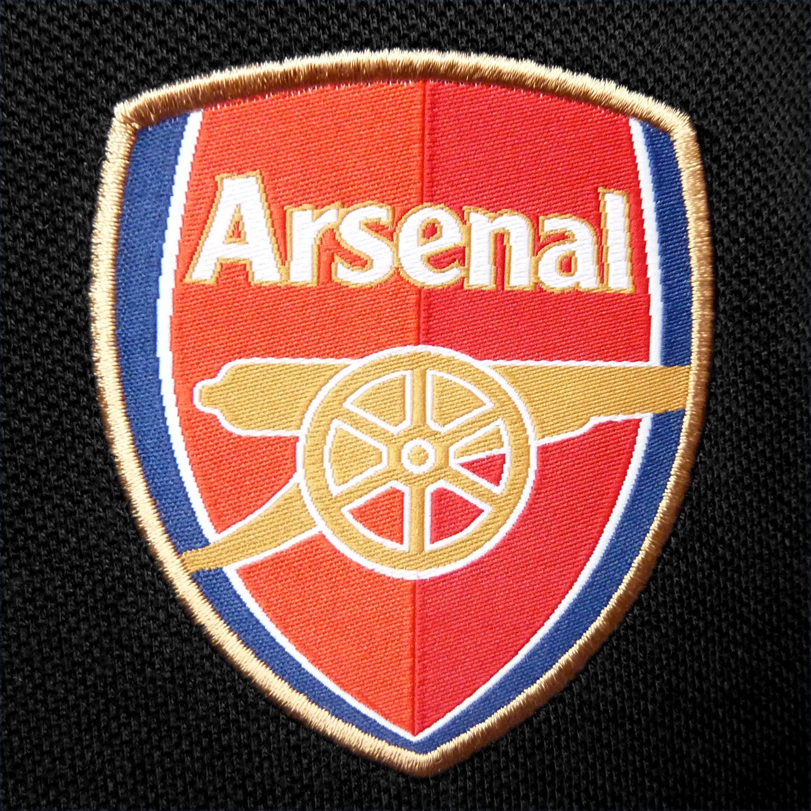 Arsenal polo shirt for adults in black with club crest and canon to chest.