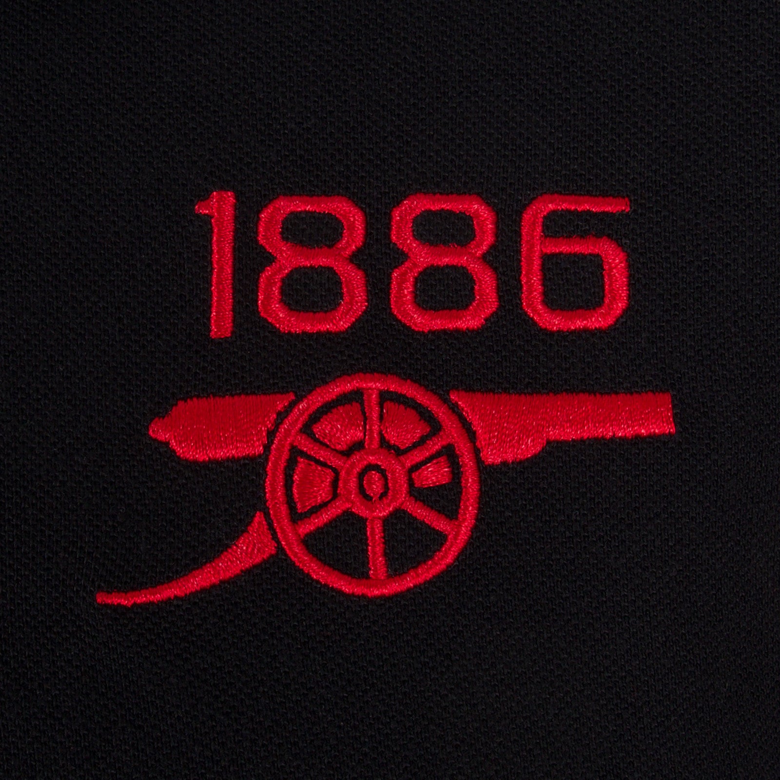 Arsenal polo shirt for adults in black with contrast sleeve, club crest and canon to chest.