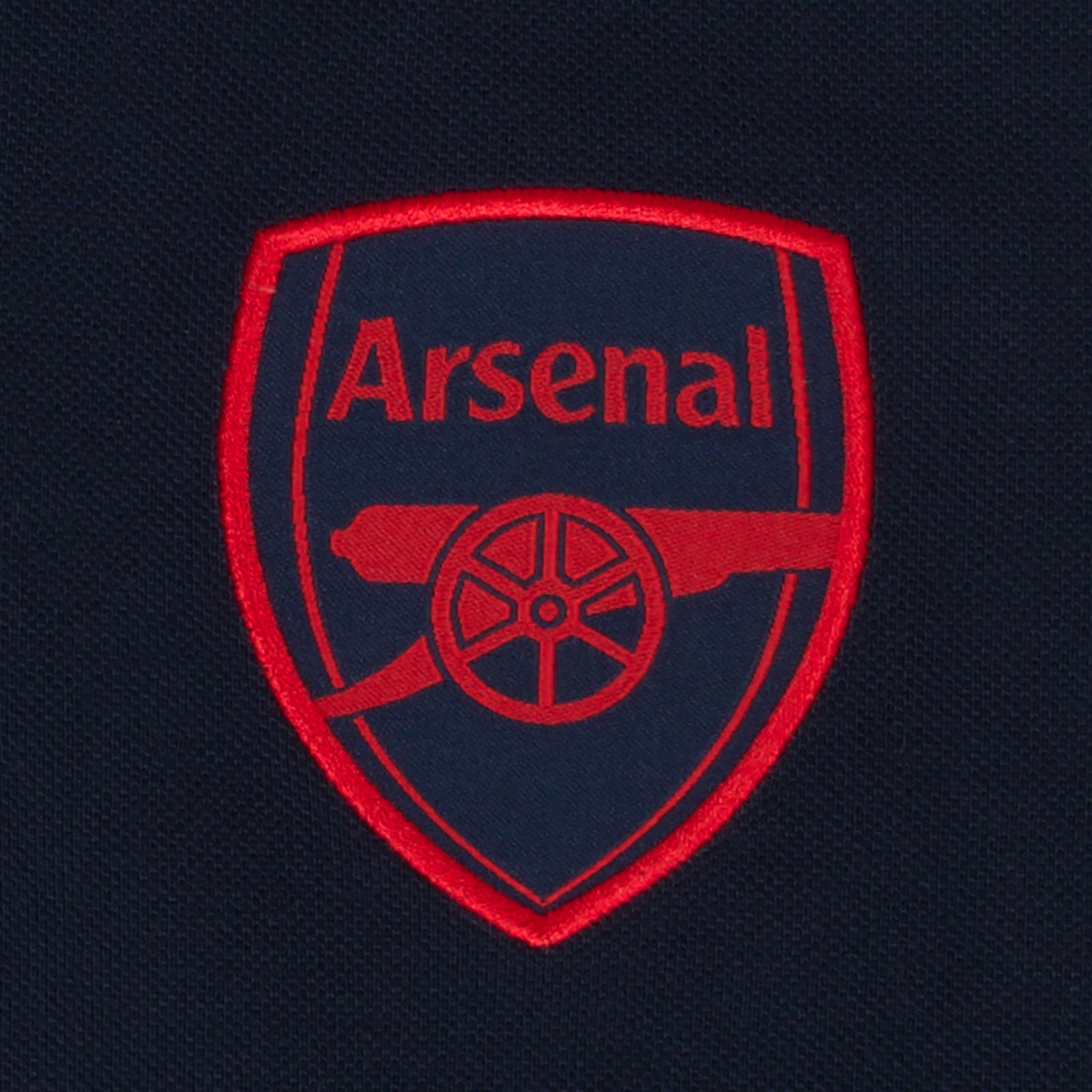 Arsenal polo shirt for adults in navy blue featuring the club crest and Champions 2026 graphic to the chest