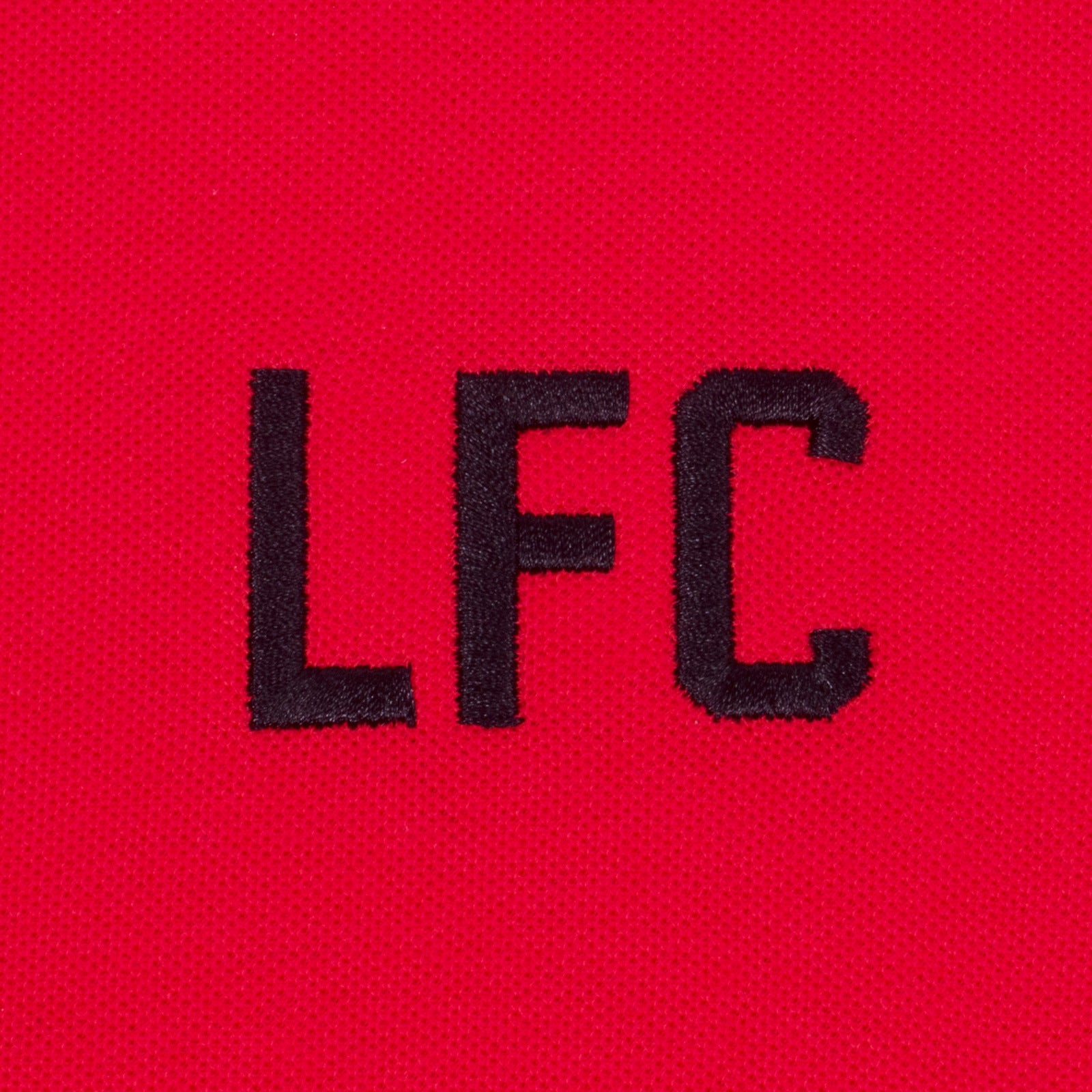 Liverpool kids polo shirt in red with LFC badge and Liverpool FC text to chest.