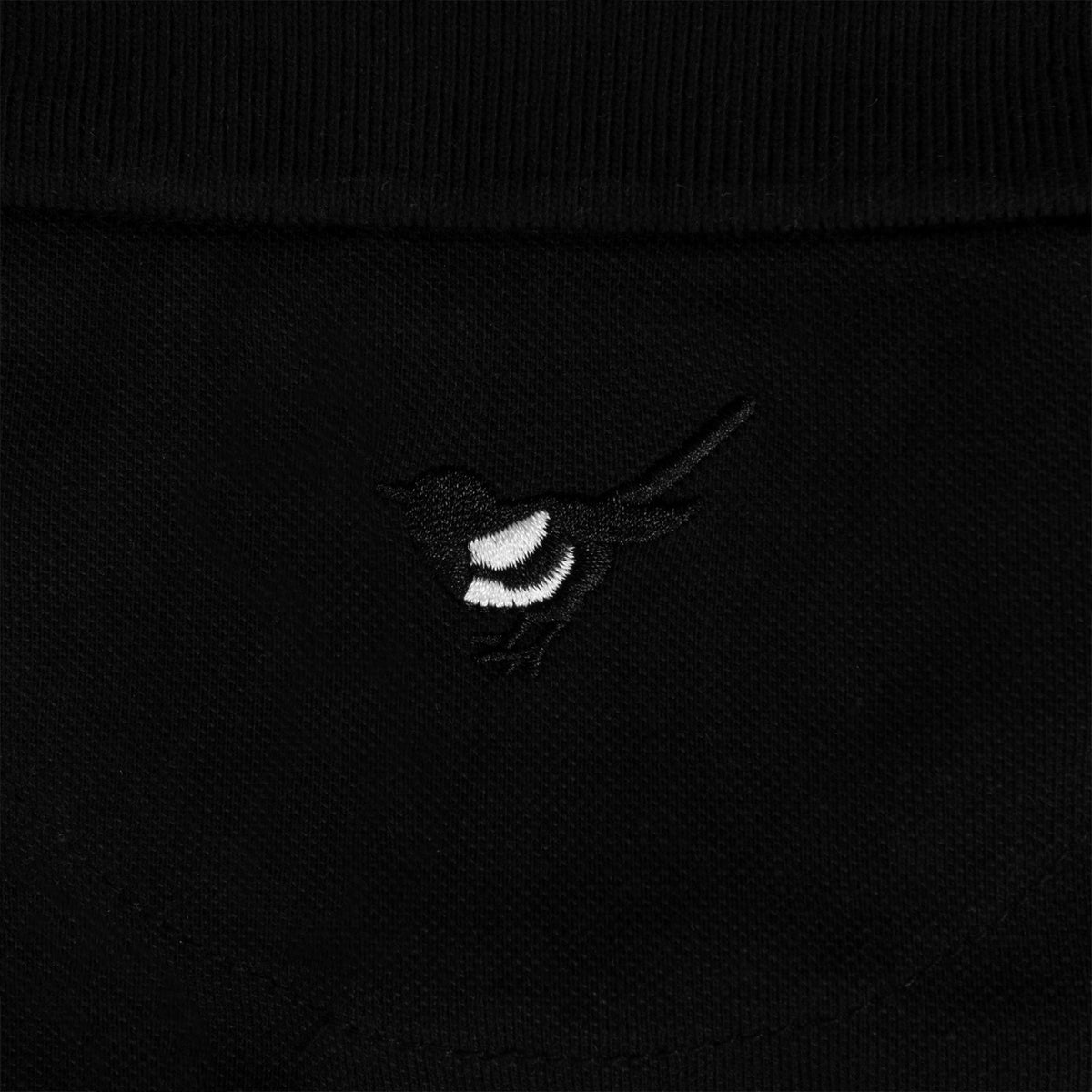Newcastle Utd adults polo shirt in black with contrast sleeve and a NUFC badge and text to chest.