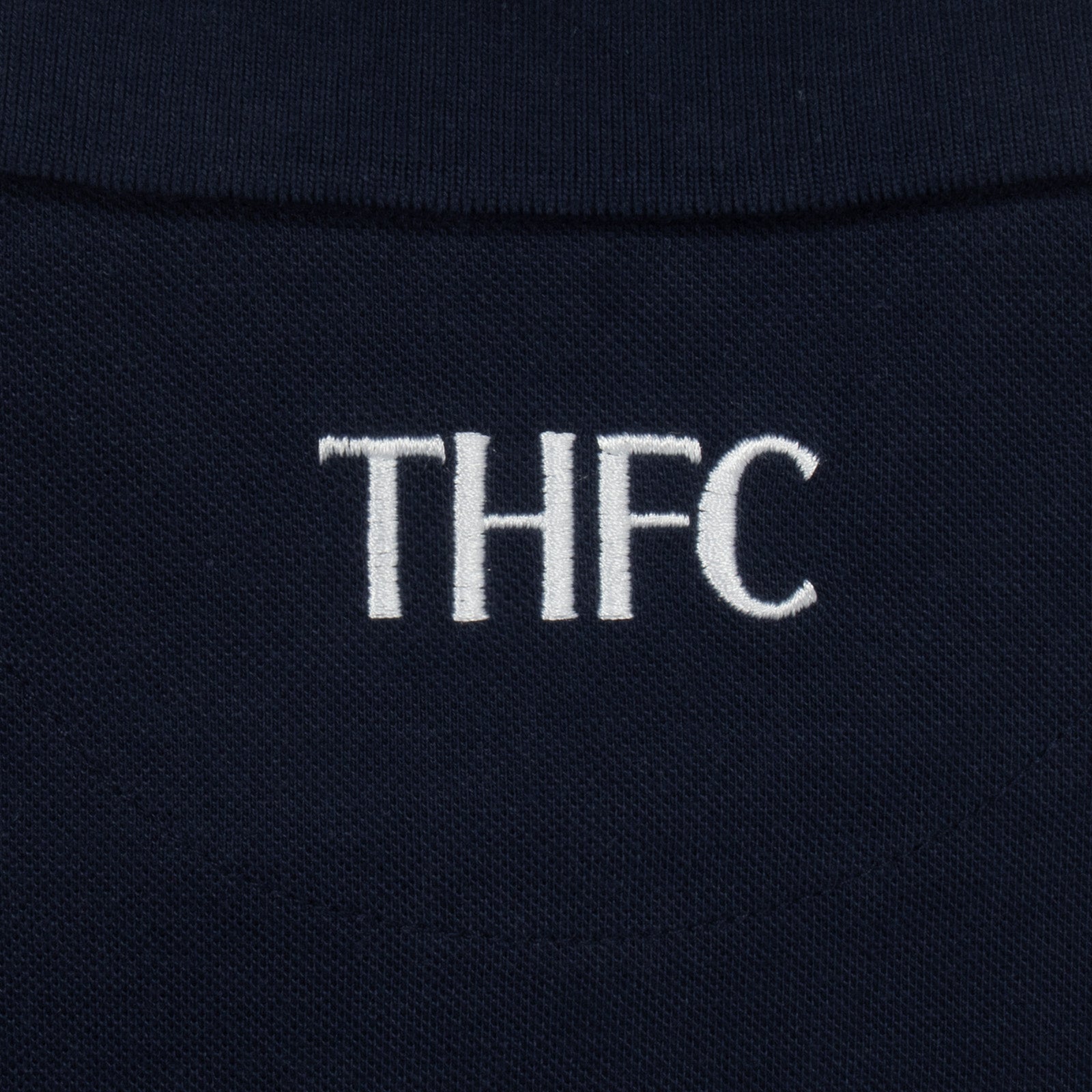 Spurs adults polo shirt in navy blue with Spurs badge and text to chest.