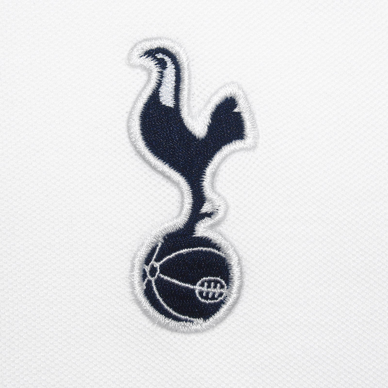 Spurs adults polo shirt in white with Spurs badge and text to chest.