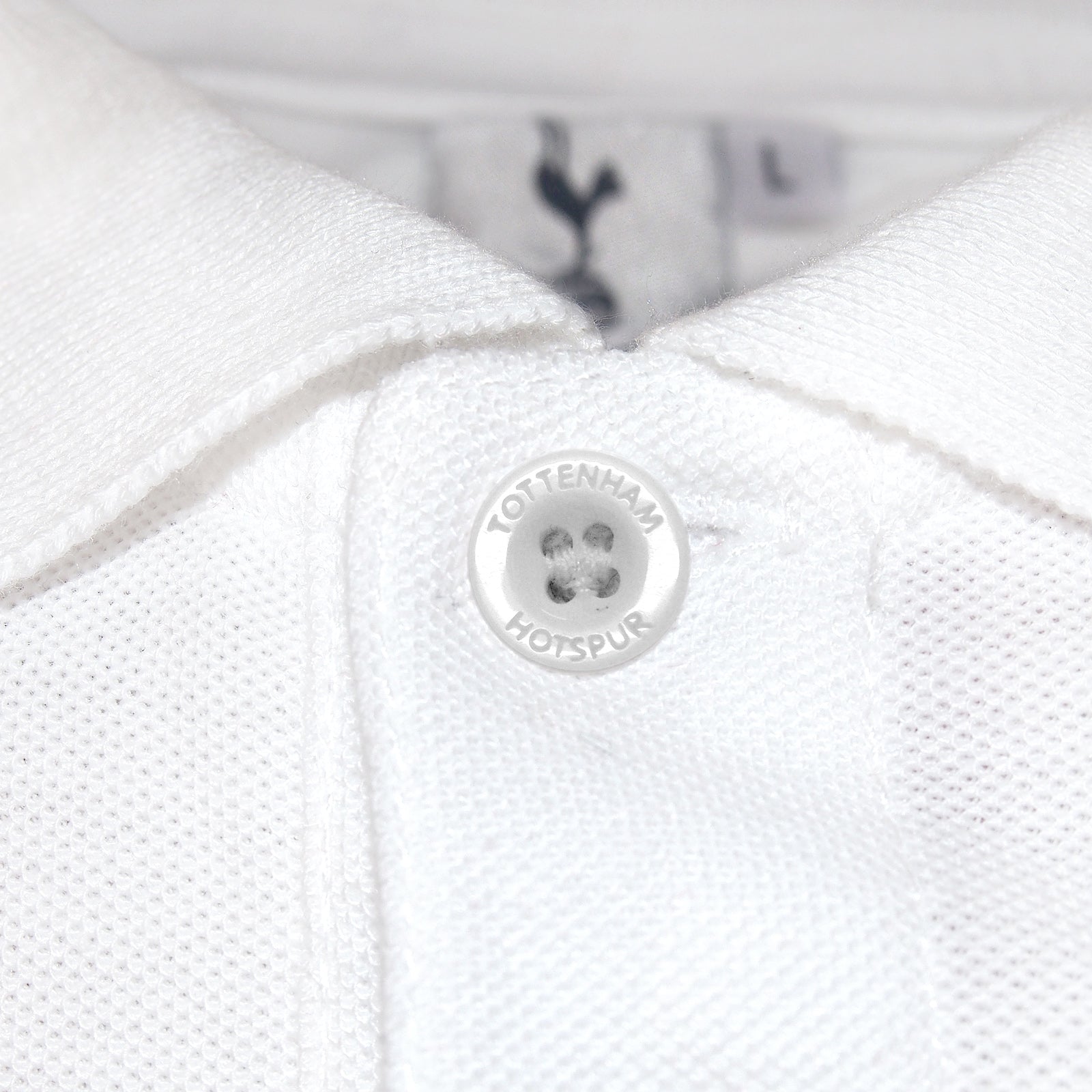 Spurs adults polo shirt in white with Spurs badge and text to chest.