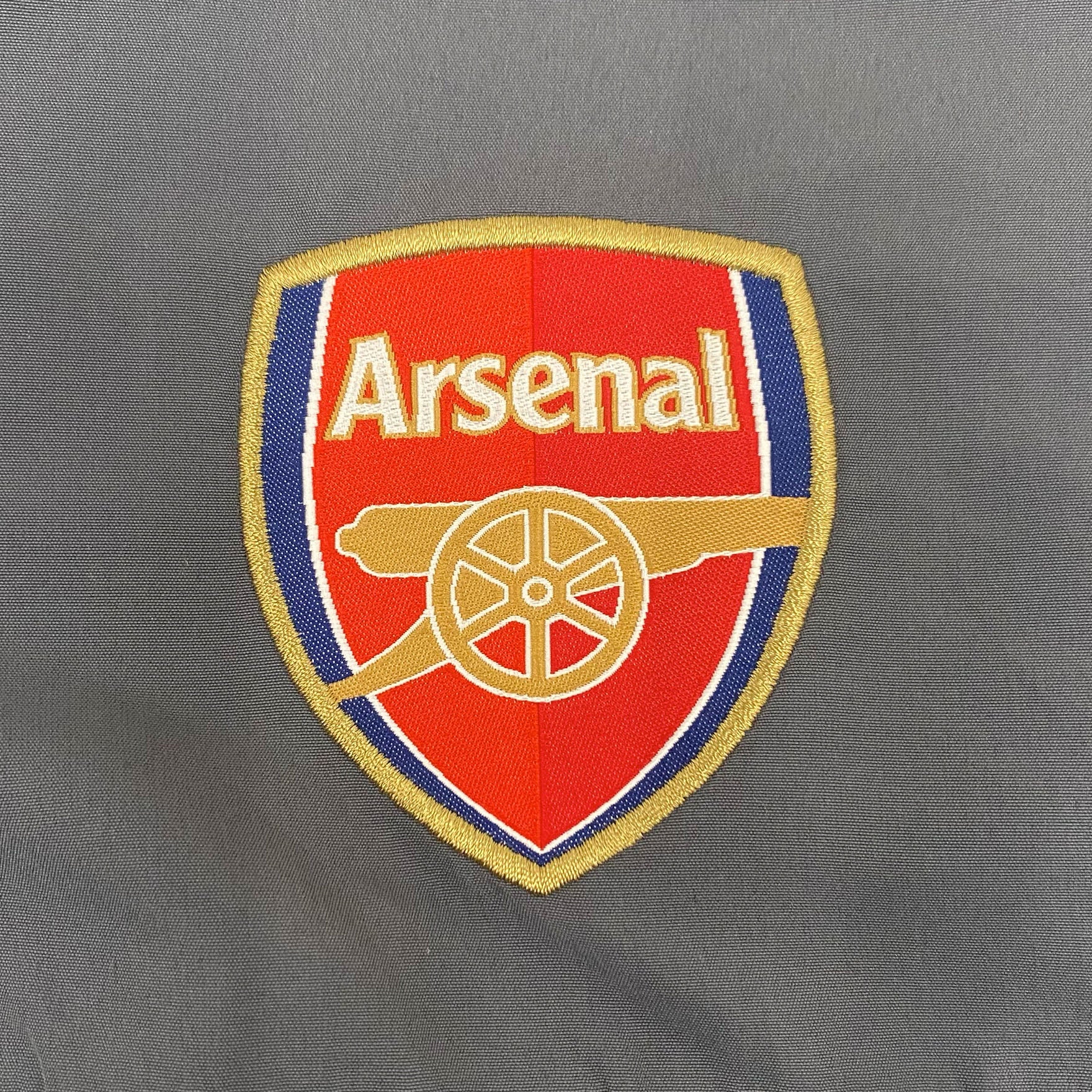 Arsenal adults tracksuit in black & grey with club crest to chest and left thigh