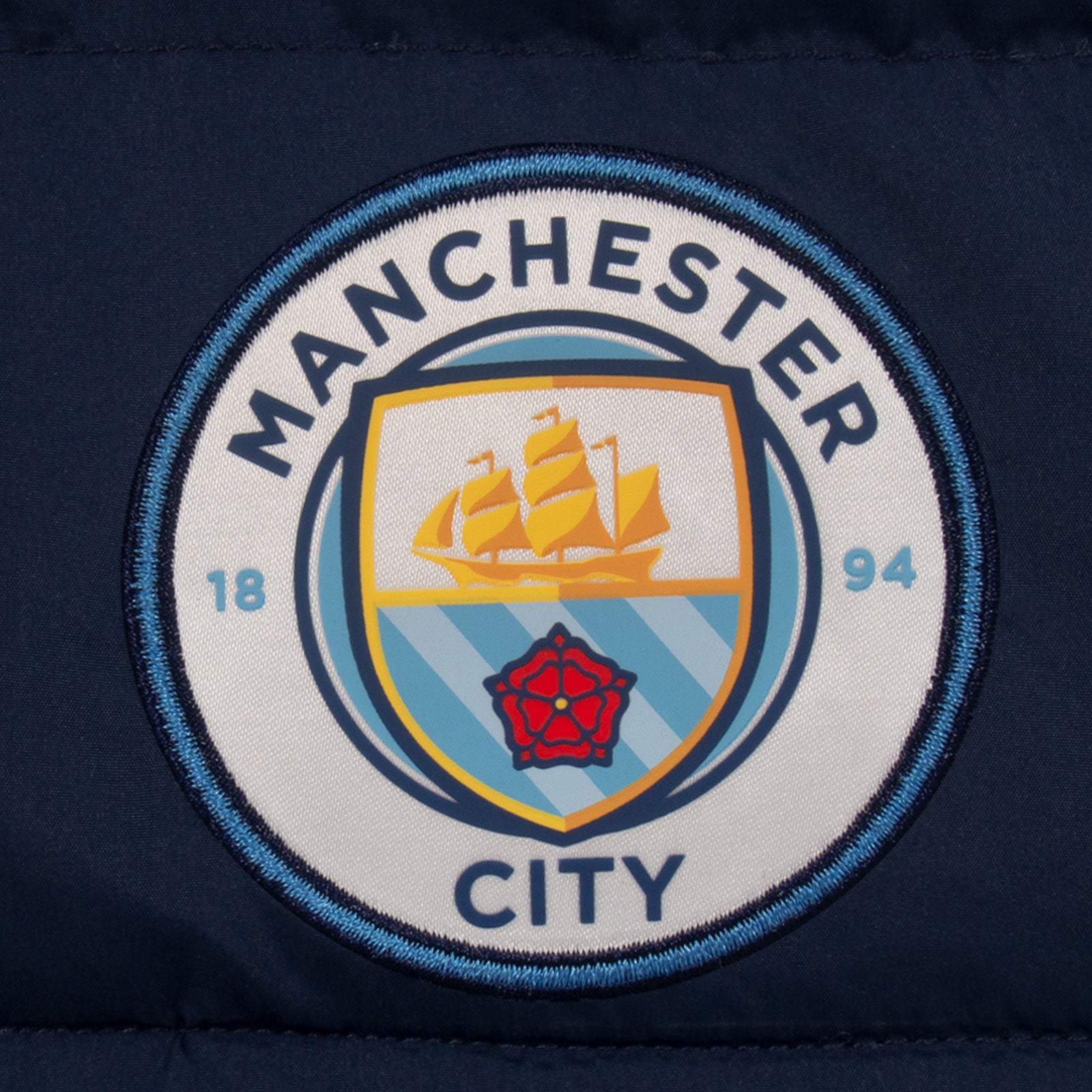 Man City kids gilet in black with full colour club crest to chest.