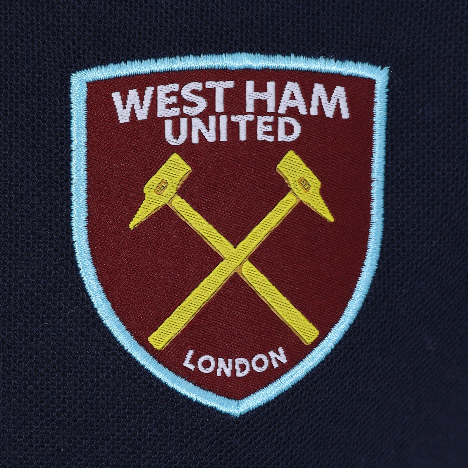 West Ham adults polo shirt in navy with WHUFC badge and text to chest.