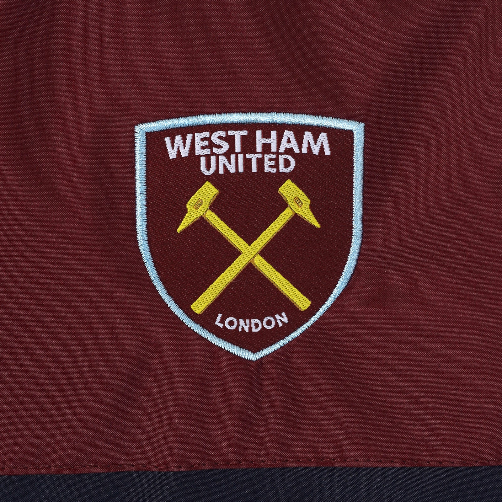 West Ham kids shower jacket in navy blue with club crest to chest.