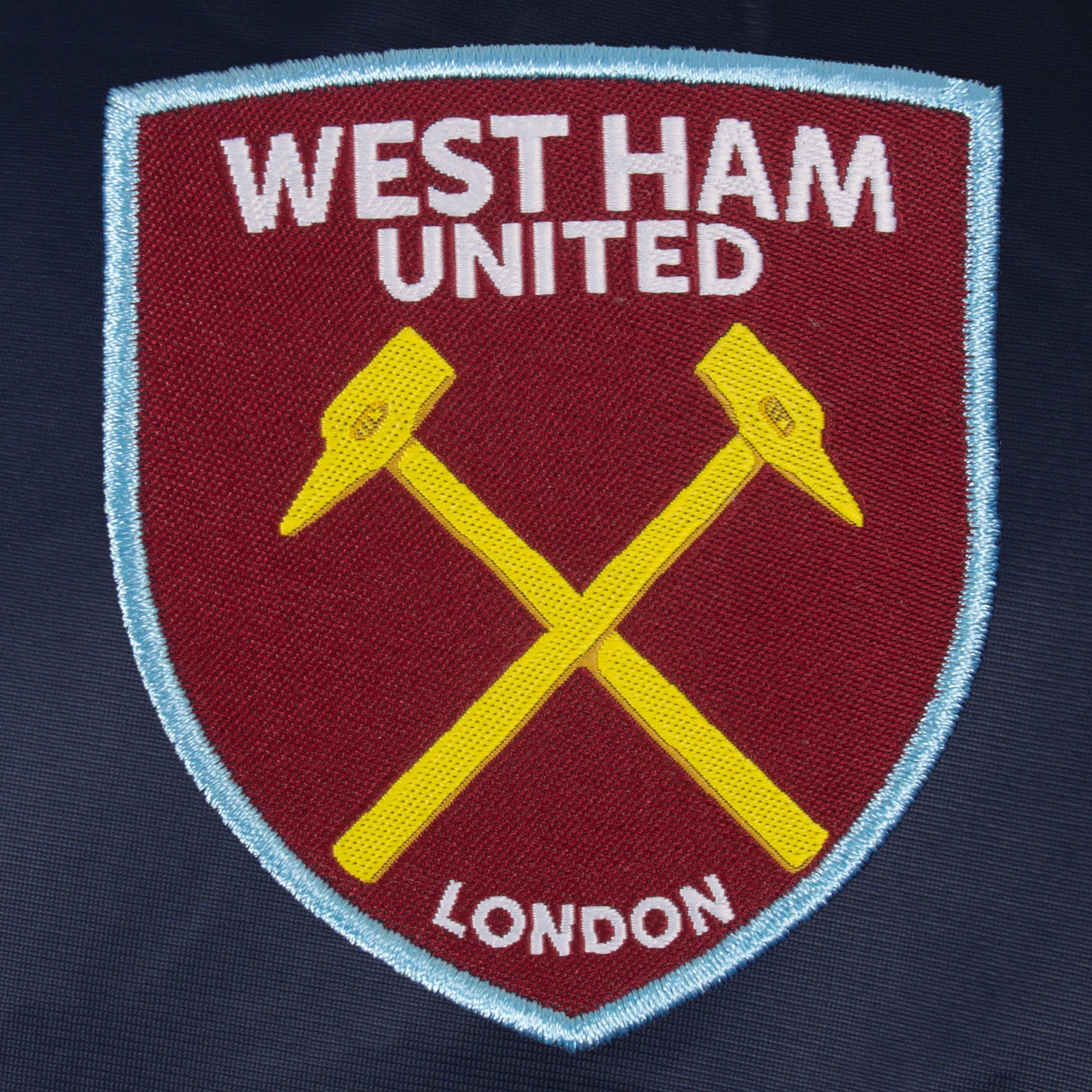 West Ham adults retro track jacket in navy blue with club crest to chest.