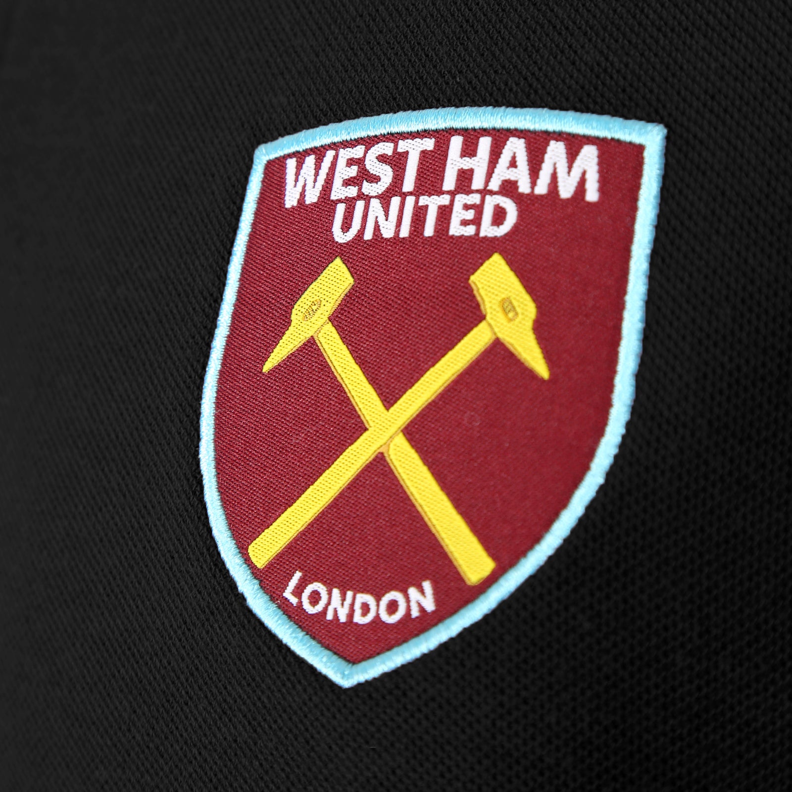 West Ham adults polo shirt in black with WHUFC badge and text to chest.