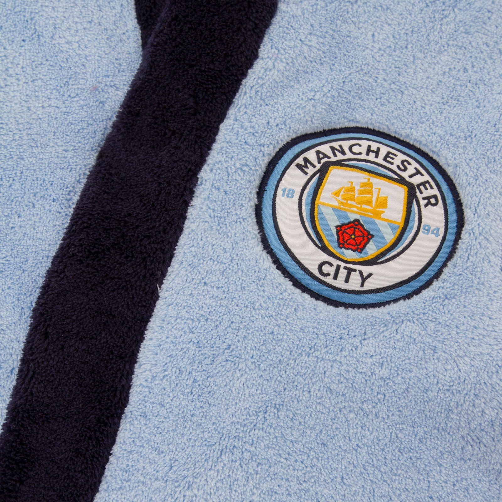 Man City kids hooded dressing gown in sky blue with crest.