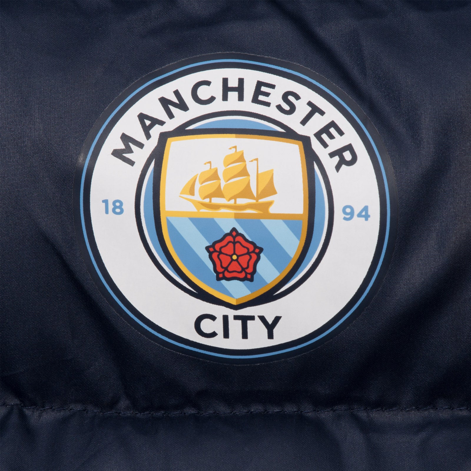 Man City kids quilted jacket in navy blue with club crest to chest.