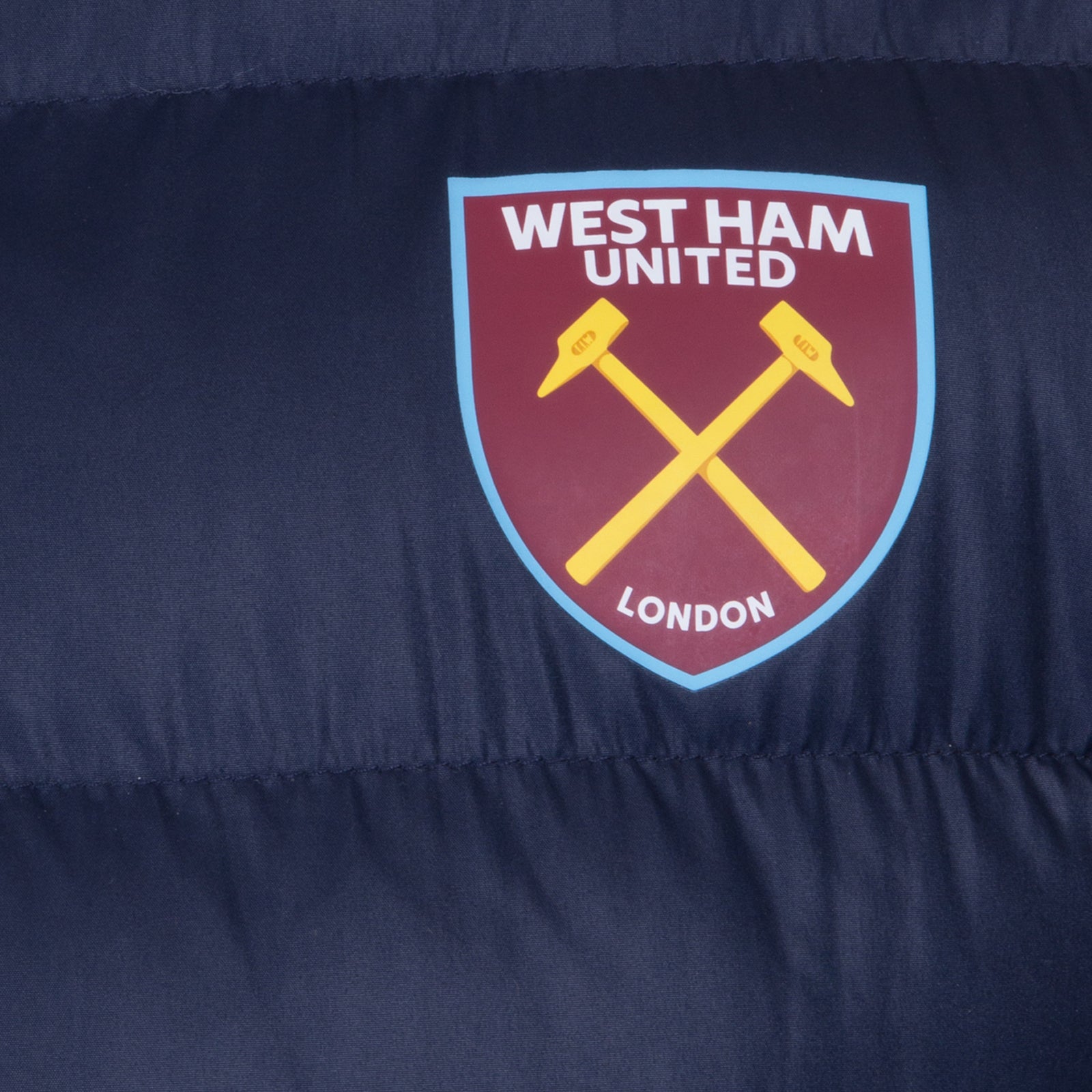 West Ham adults quilted jacket in navy blue with club crest to chest.