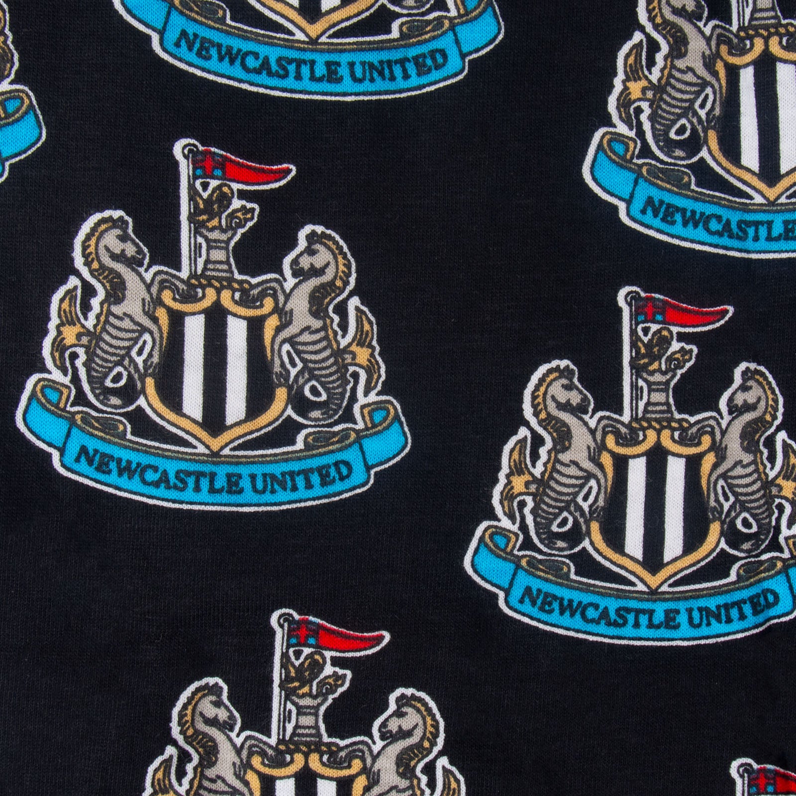 Newcastle Utd baby pyjamas in black with long sleeve top and crest & text to chest plus matching bottoms