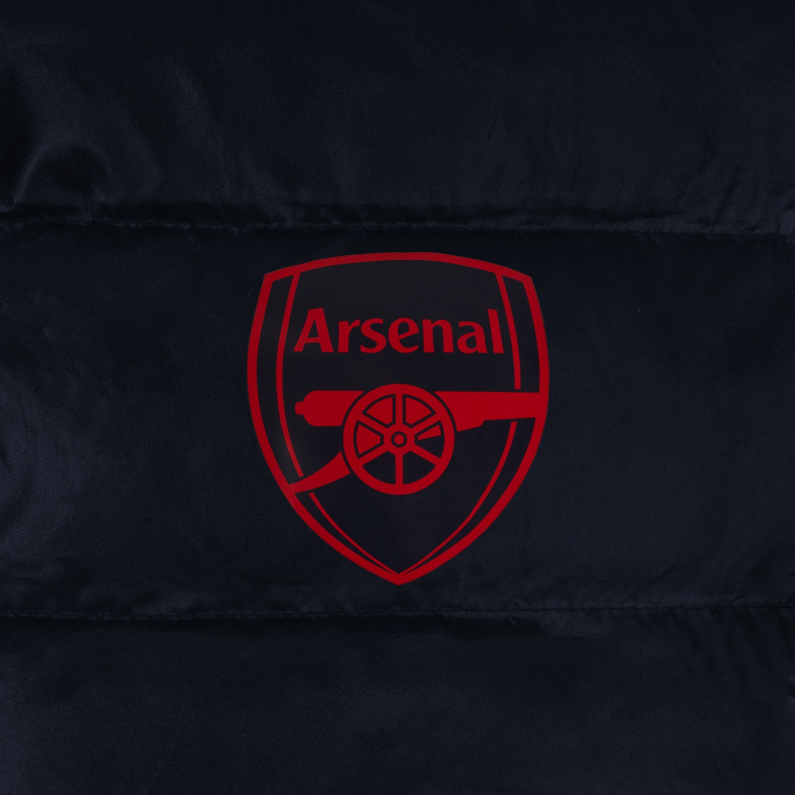 Arsenal adults quilted jacket in navy blue with club crest to chest.