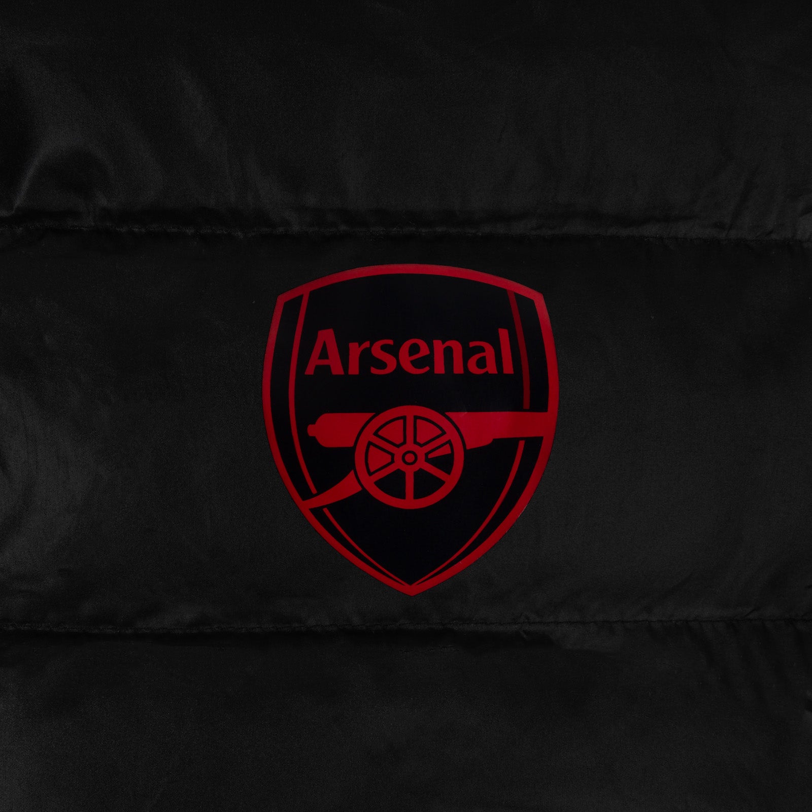 Arsenal kids quilted jacket in black with club crest to chest.