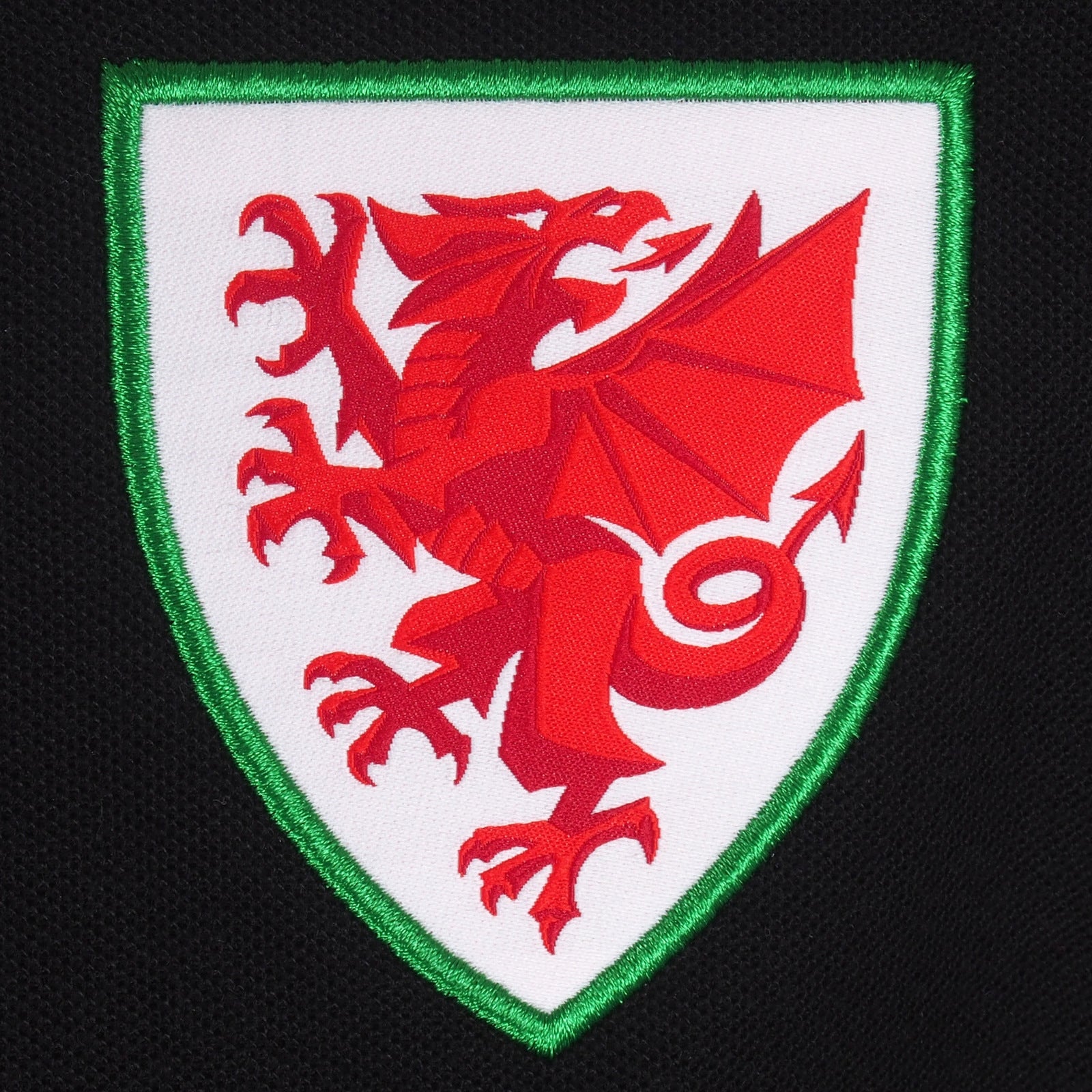 Wales adults polo shirt in black with Cymru badge to the chest.