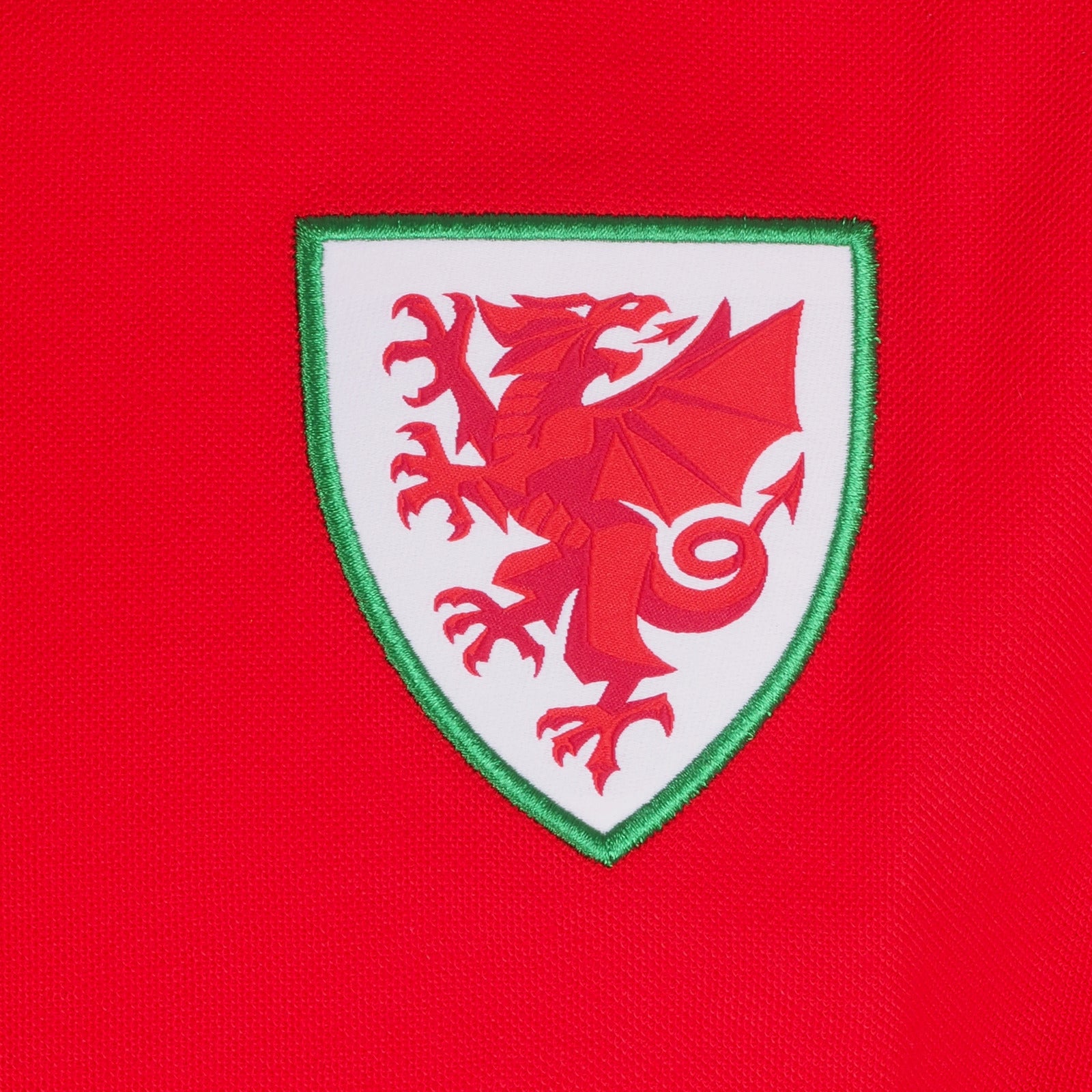 Wales adults polo shirt in red with contrast sleeve and Cymru badge to the chest.