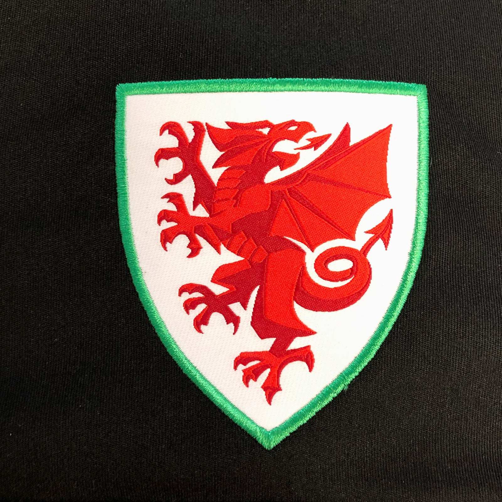 Wales FA adults poly T-shirt in black with woven national crest to chest