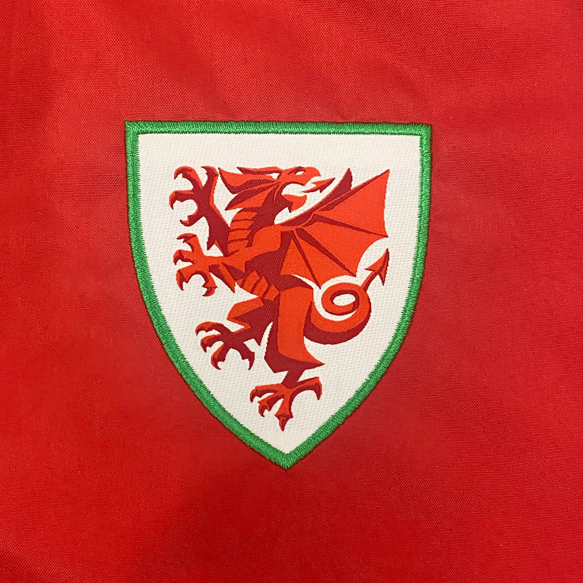 Wales kids shower jacket in black with Wales FA club badge to the left chest.