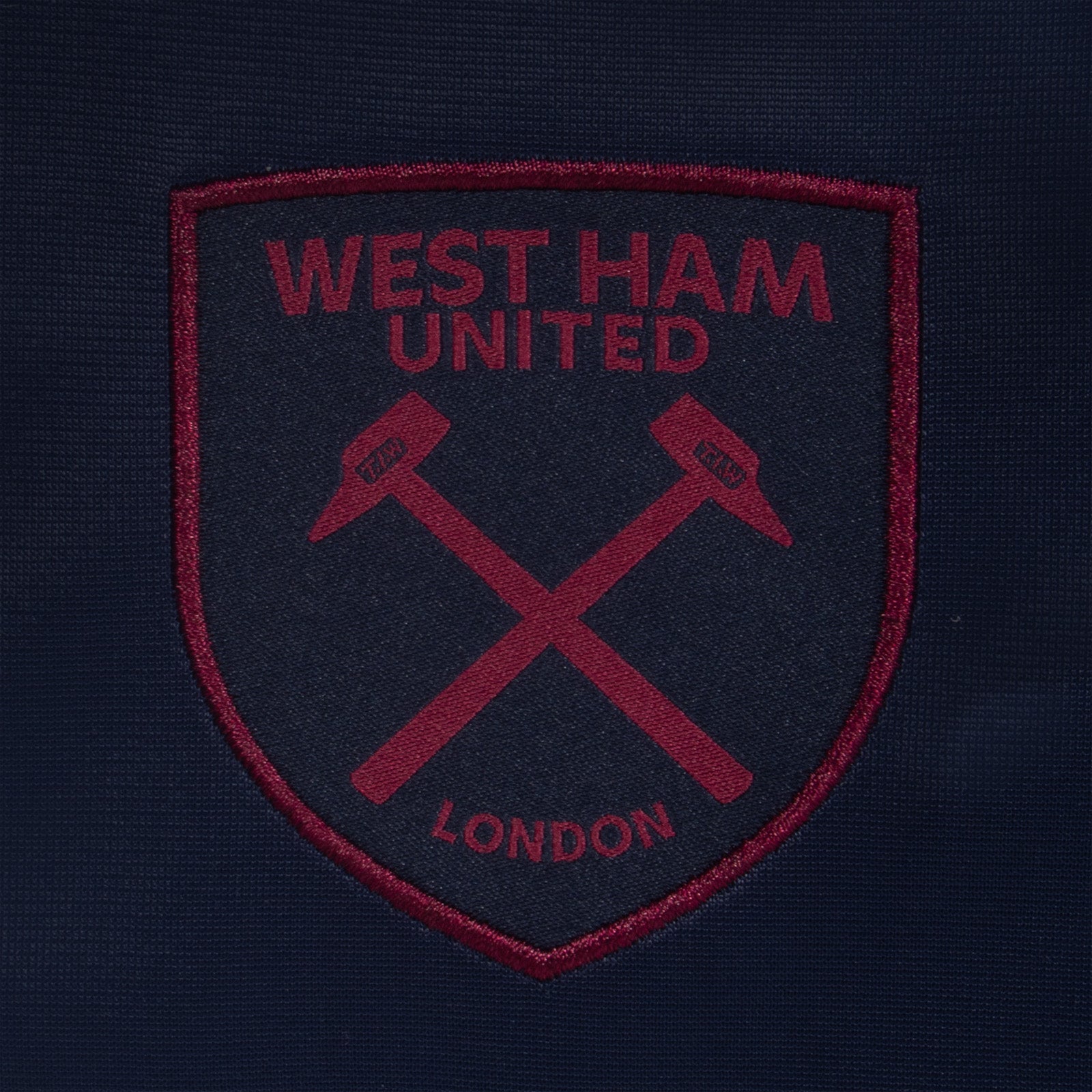 West Ham United kids taped tracksuit in navy blue with club crest and text to both top & pants