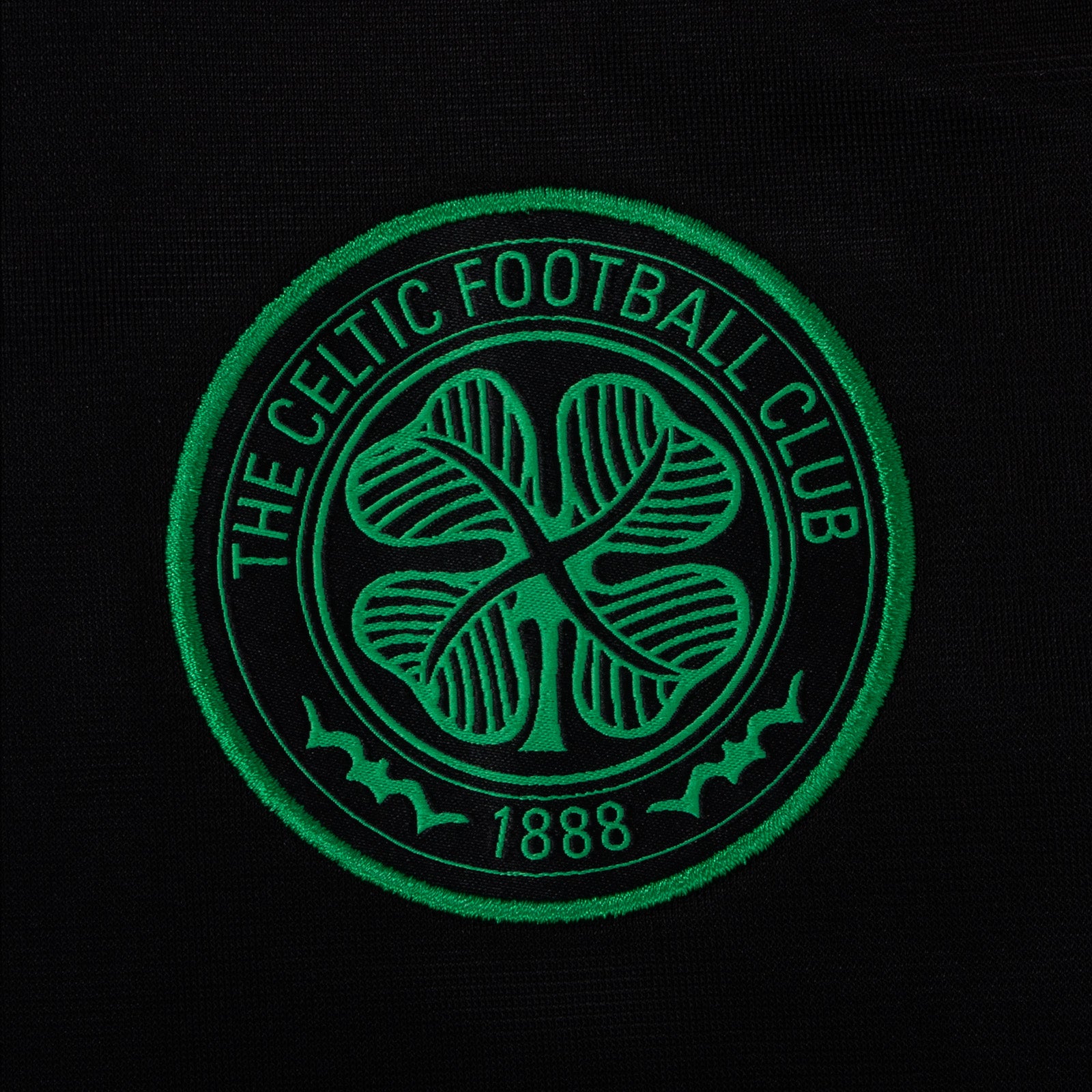 Celtic adults taped tracksuit in black with club crest and text to both top & pants