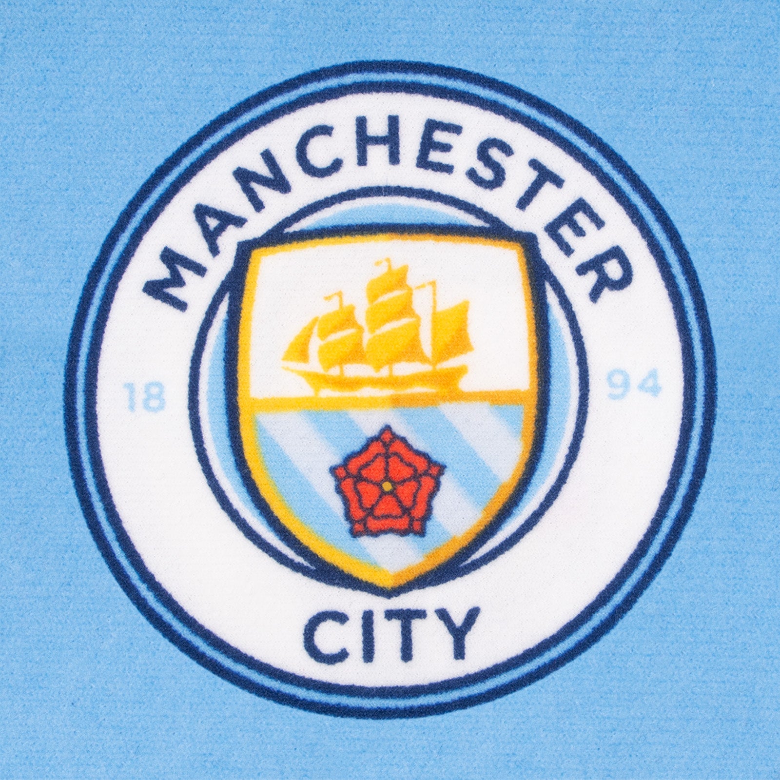 Manchester City kids loungewear pyjama set. Short sleeve t-shirt in white with Man City crest to chest. Long pants in sky blue with all-over print of the club crest