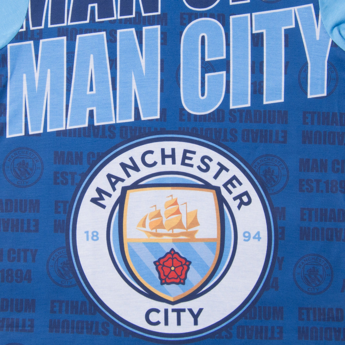 Man City kids pyjamas in navy blue. Short sleeve top with graphic and shorts with crest to the left leg